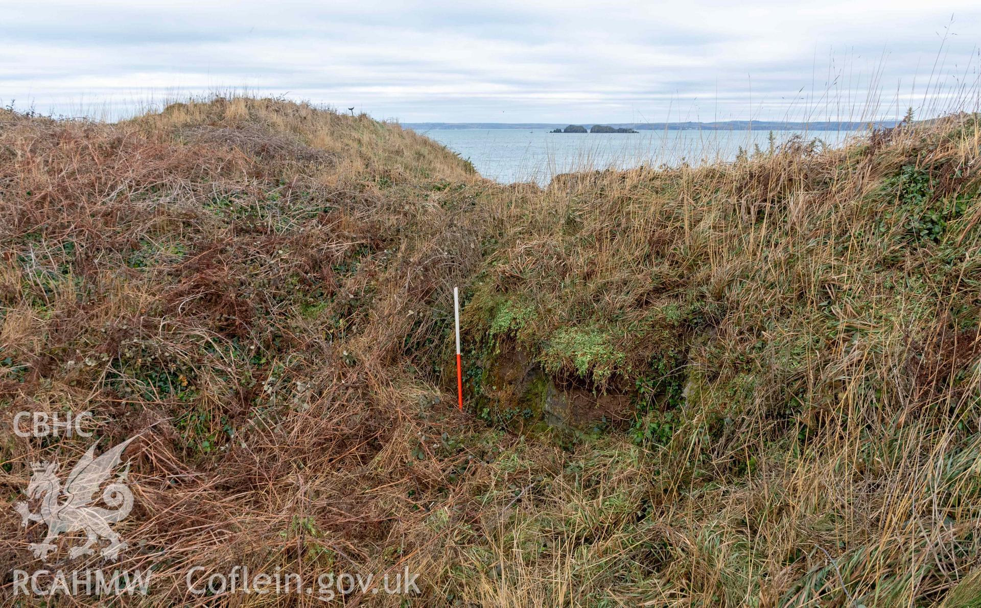 Castle Head Coastal Promontory Fort. Quarried edge of inner ditch defining the west side of entrance causeway (with scale).