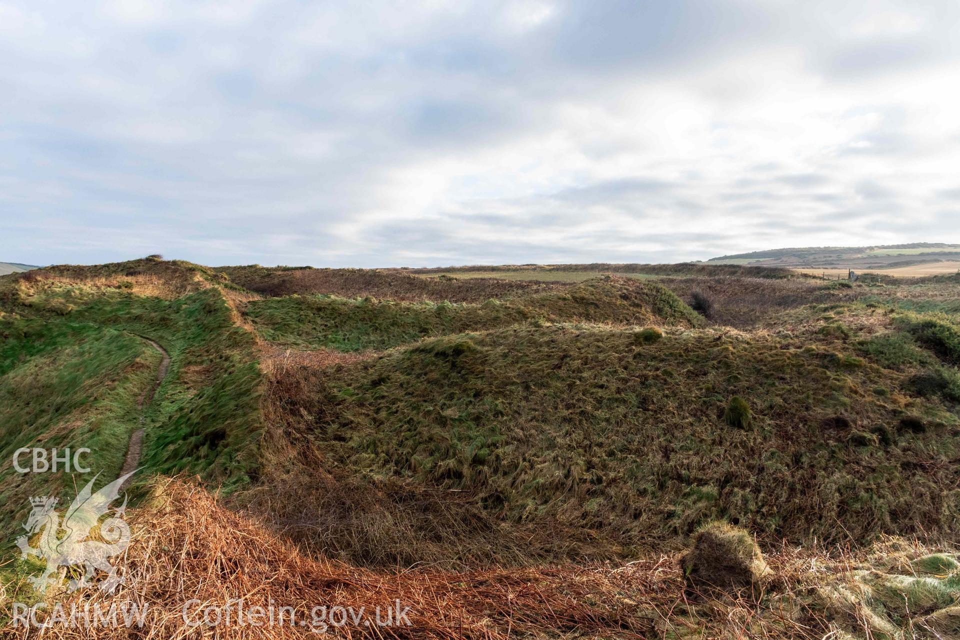 Caer Aber Pwll coastal promontory fort. Looking east from the western edge of the fort across the outer and middle defences.