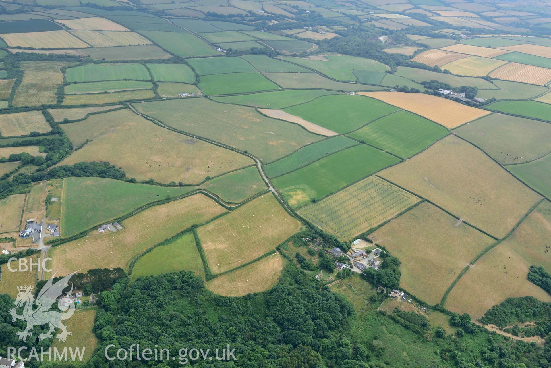 RCAHMW colour oblique aerial photograph of Woodlands Farm defended enclosure from NW taken on 11 July 2018 by Toby Driver