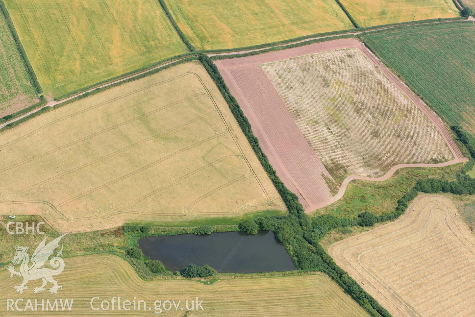 RCAHMW colour oblique aerial photograph of Long lane cropmark enclosure, Hasguard Hall taken on 11 July 2018 by Toby Driver