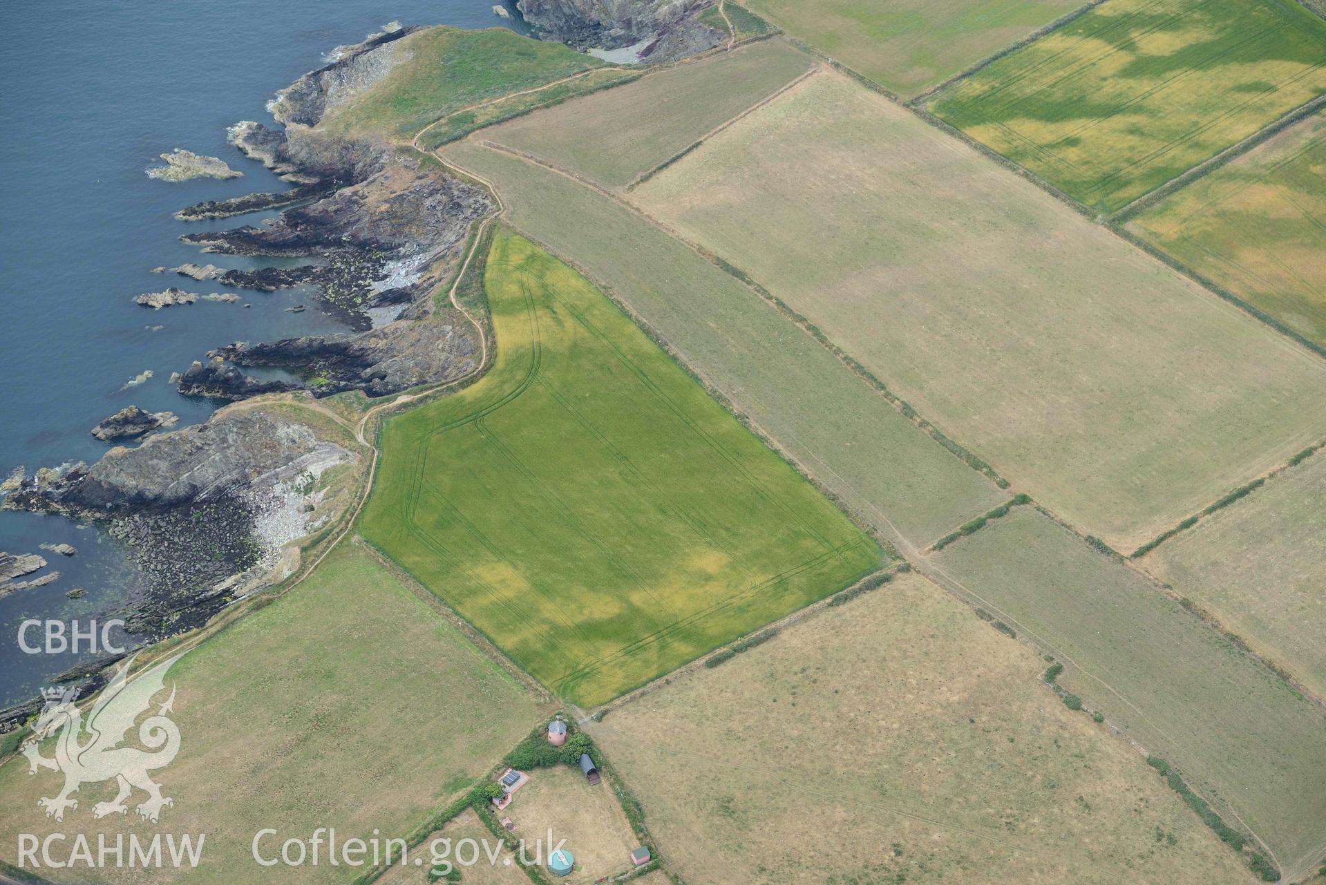 RCAHMW colour oblique aerial photograph of St Justinian's chapel, geological cropmarks NW of taken on 11 July 2018 by Toby Driver