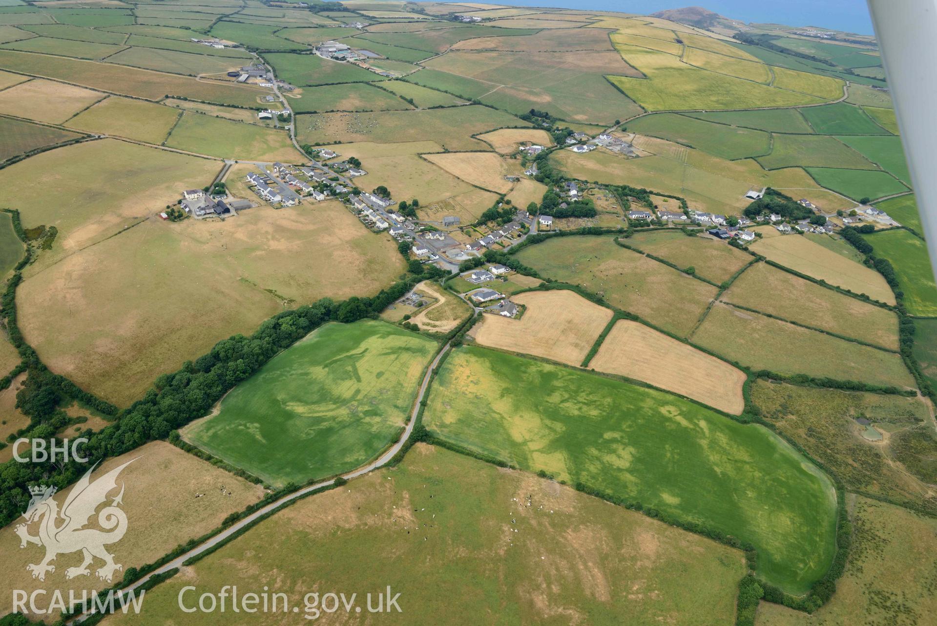 RCAHMW colour oblique aerial photograph of Ty Gwyn enclosure cropmark taken on 11 July 2018 by Toby Driver