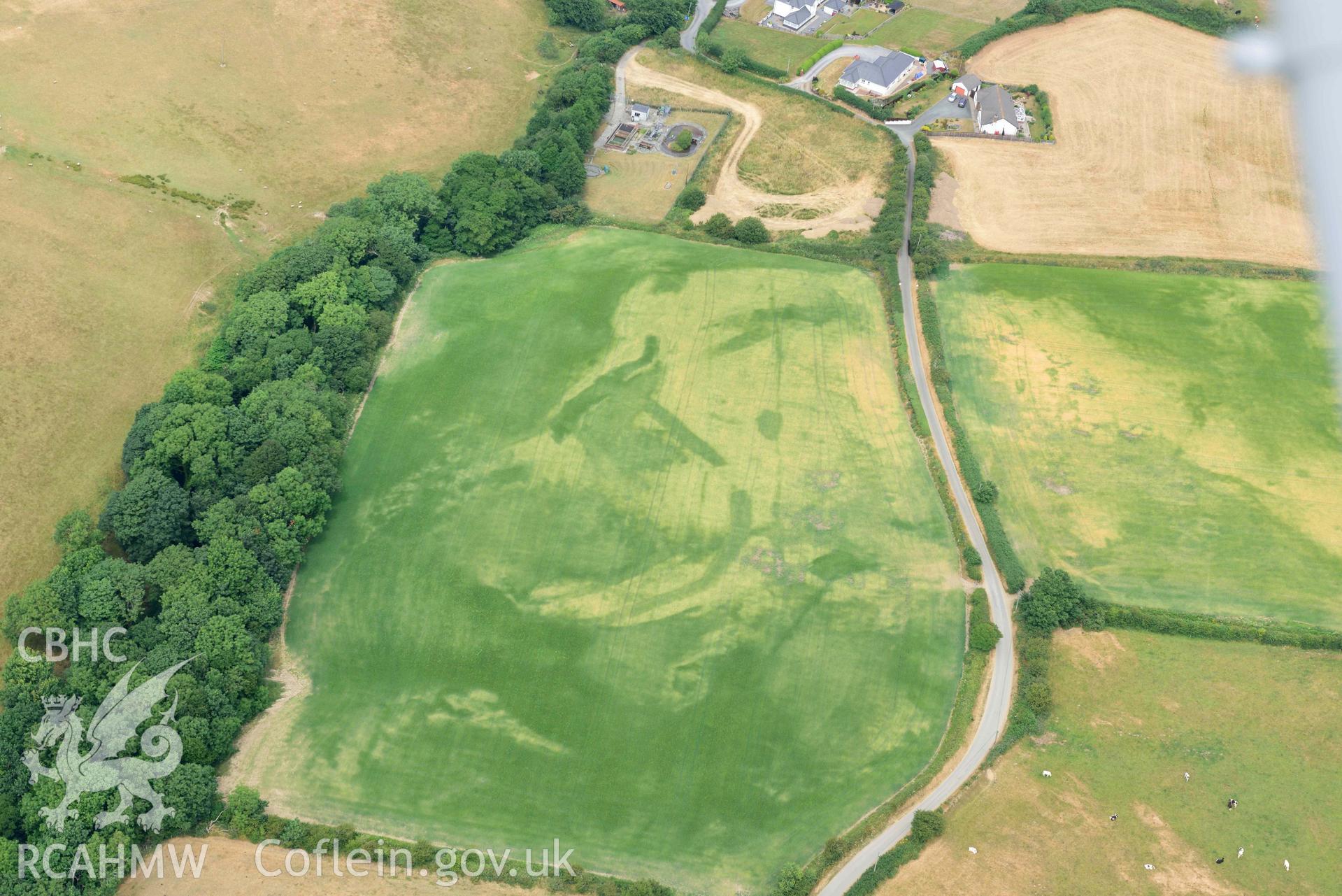 RCAHMW colour oblique aerial photograph of Ty Gwyn enclosure cropmark taken on 11 July 2018 by Toby Driver