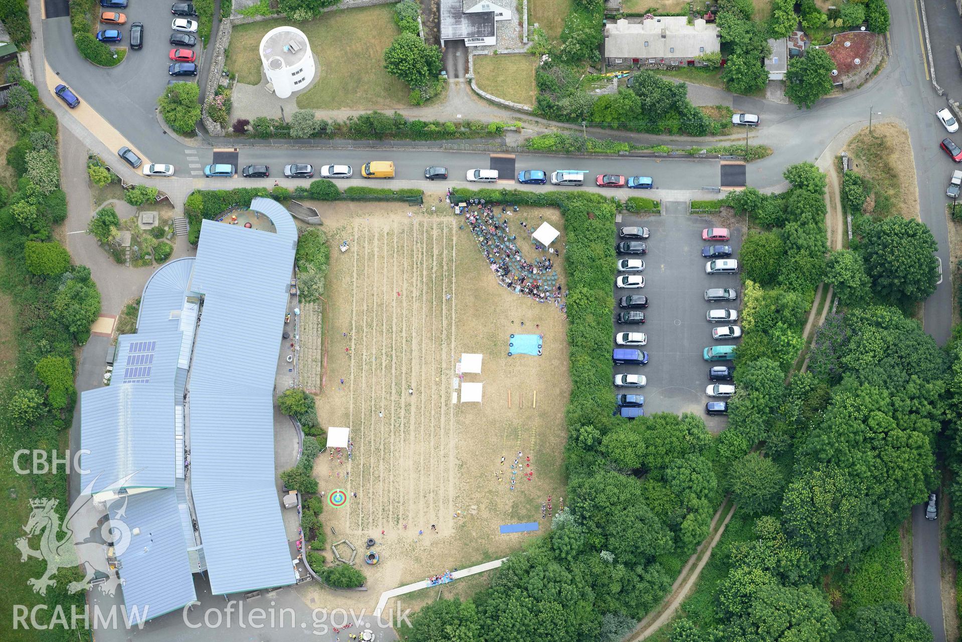 RCAHMW colour oblique aerial photograph of County Primary School St David's - during sports day and Round House taken on 11 July 2018 by Toby Driver