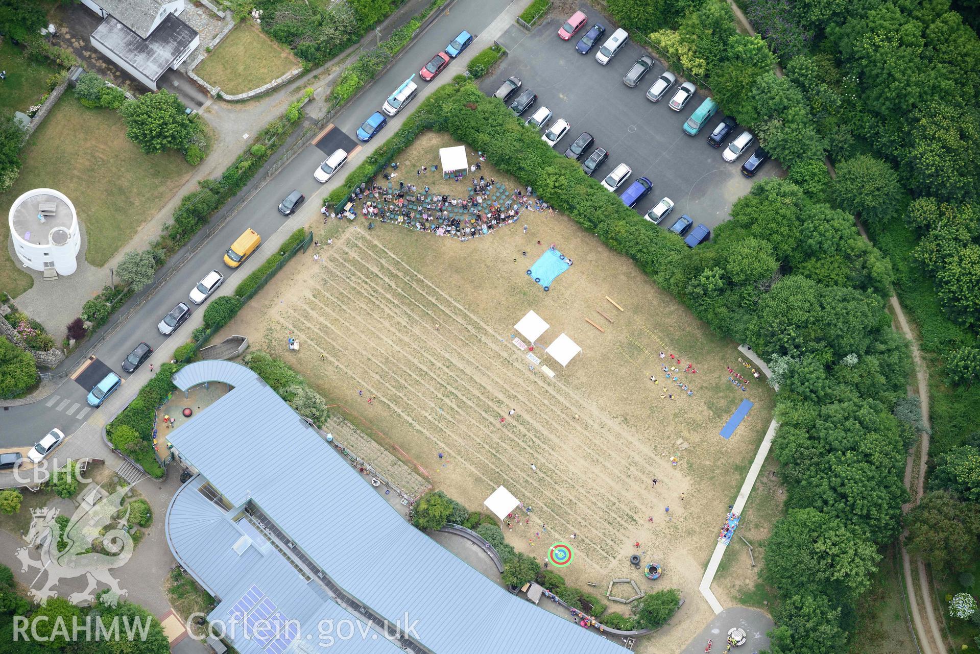 RCAHMW colour oblique aerial photograph of County Primary School St David's - during sports day and Round House taken on 11 July 2018 by Toby Driver