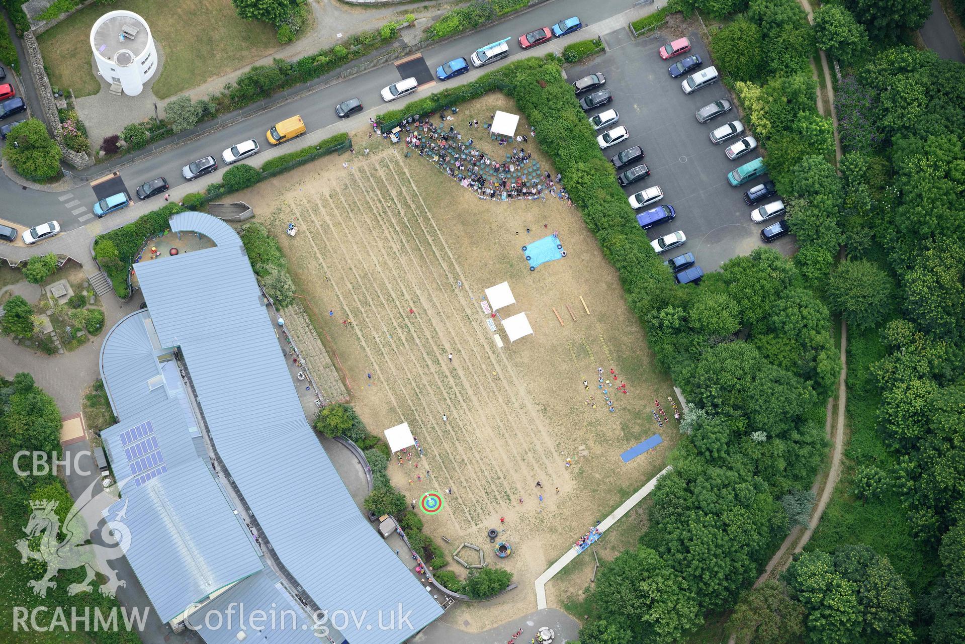 RCAHMW colour oblique aerial photograph of County Primary School St David's - during sports day and Round House taken on 11 July 2018 by Toby Driver