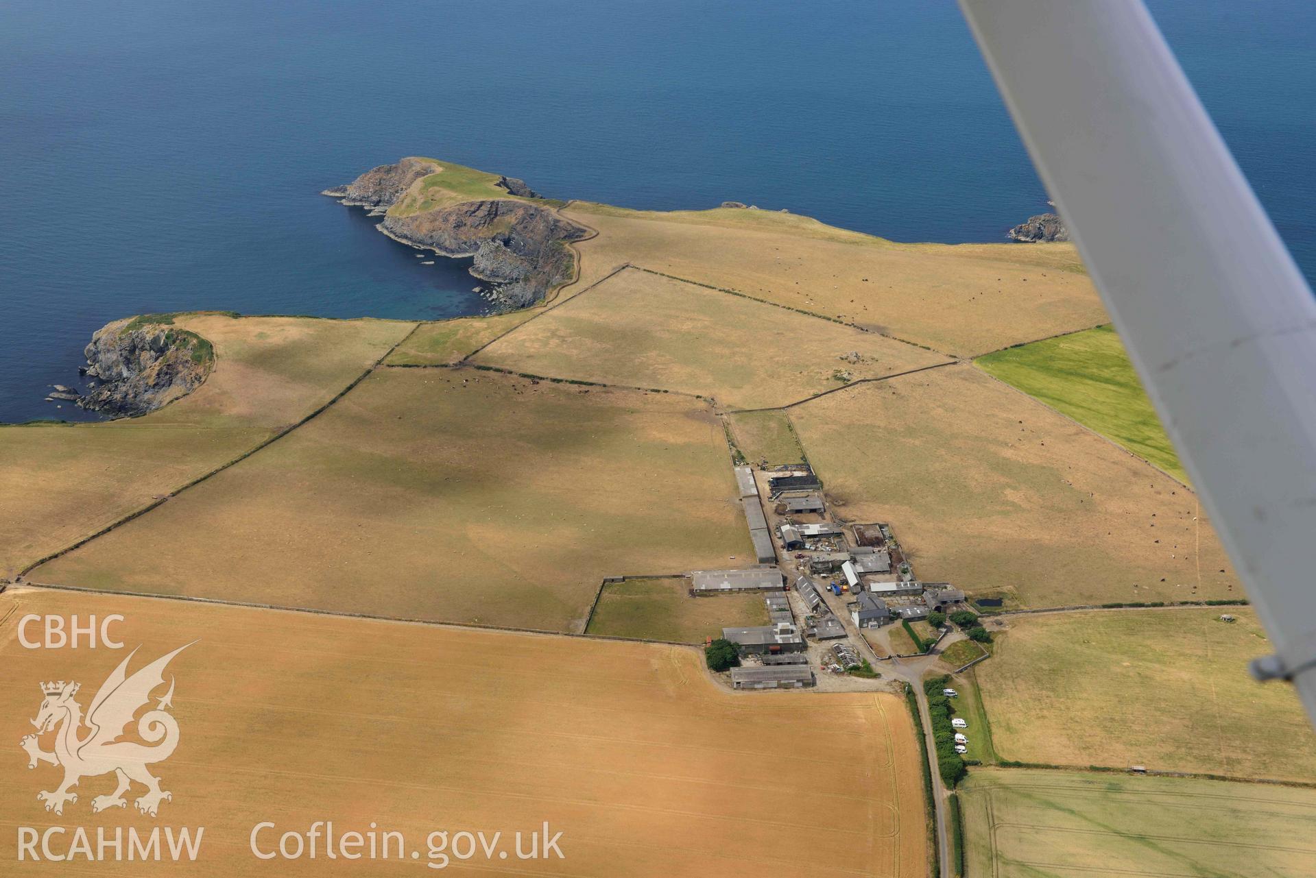 RCAHMW colour oblique aerial photograph of Longhouse with parched landscape taken on 11 July 2018 by Toby Driver