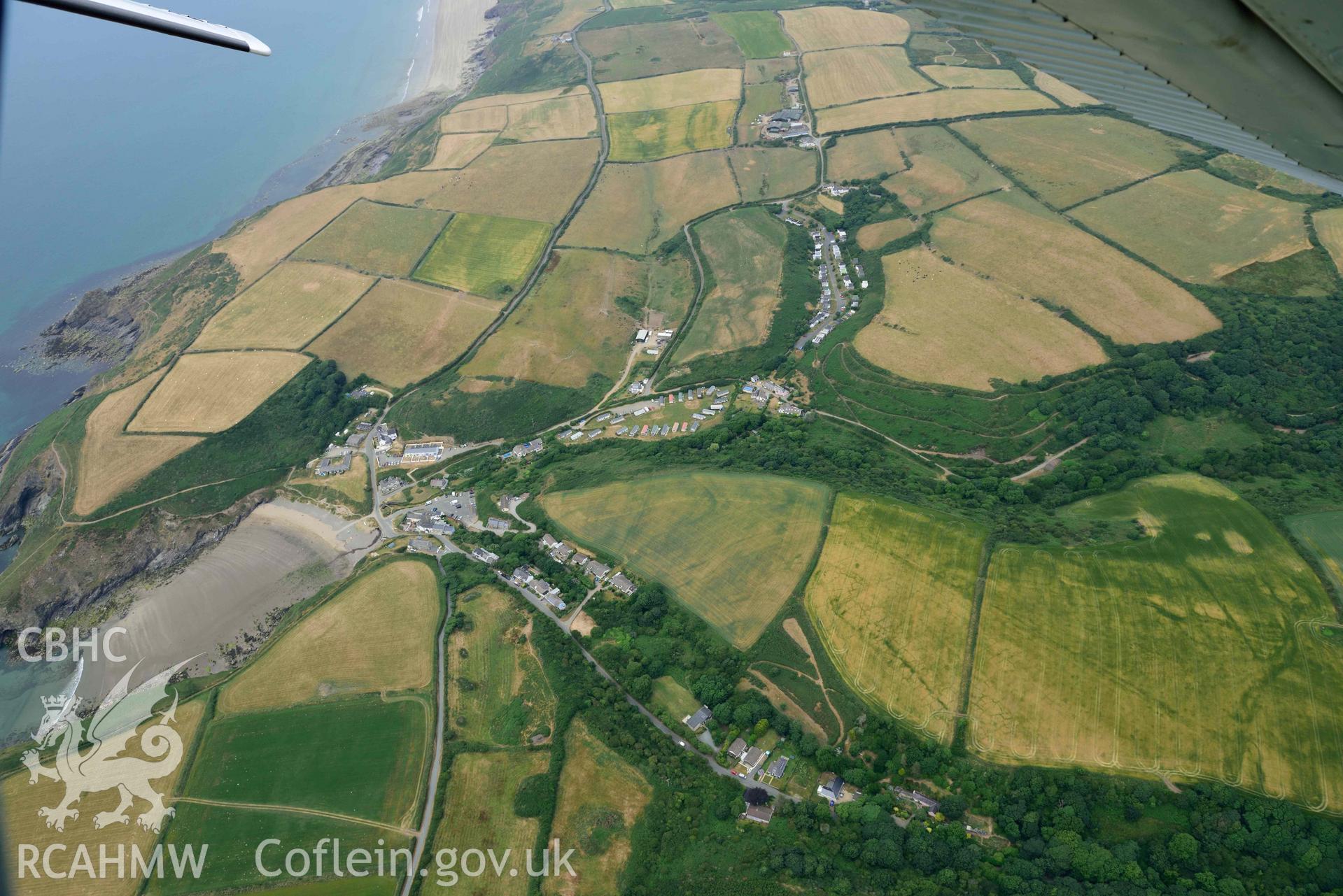 RCAHMW colour oblique aerial photograph of Nolton Haven village, with geoloigcal cropmarks taken on 11 July 2018 by Toby Driver