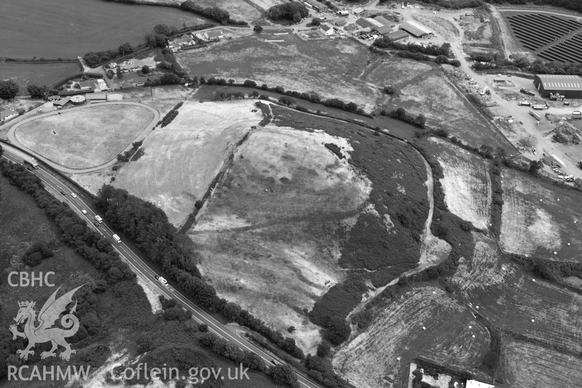 RCAHMW black and white oblique aerial photograph of Banc y Warren hillfort taken on 11 July 2018 by Toby Driver