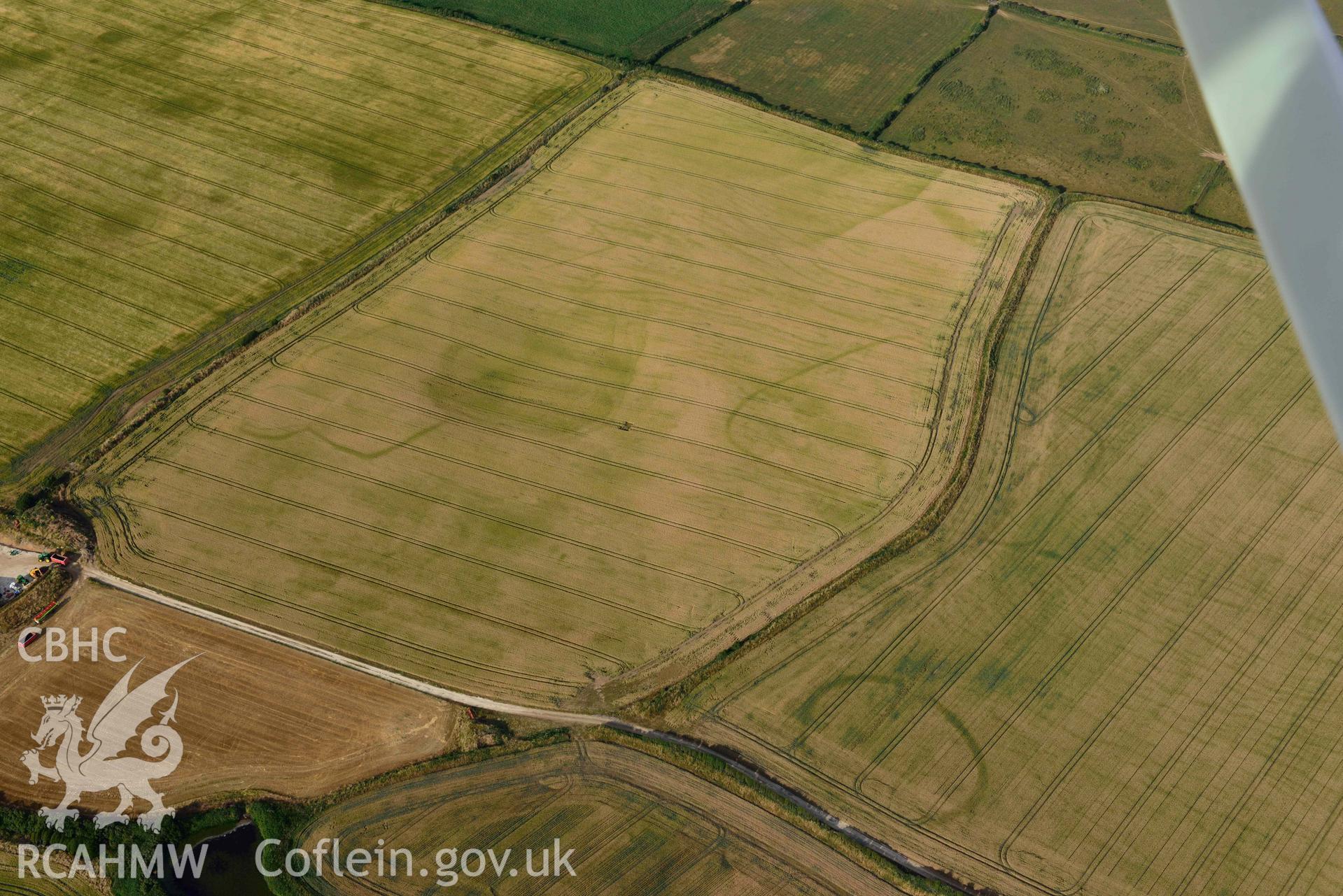 RCAHMW colour oblique aerial photograph of Paviland Manor, cropmark complex; SW circular enclosure & polygonal enclosure, from SW taken on 17 July 2018 by Toby Driver (NGR: SS449861)