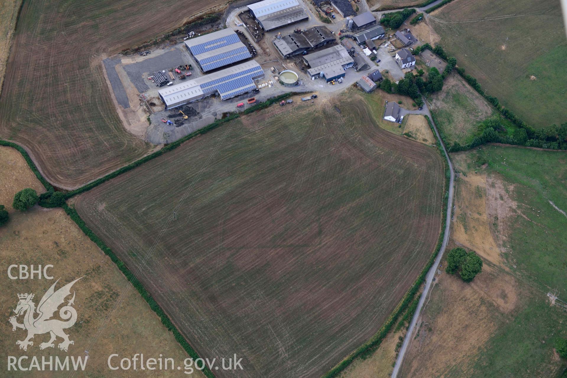 RCAHMW black and white oblique aerial photograph of Trebersed enclosure or villa taken on 17 July 2018 by Toby Driver