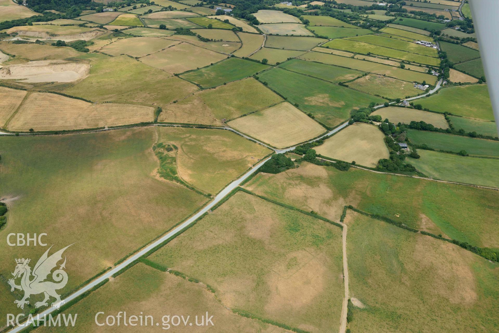 RCAHMW colour oblique aerial photograph of Crugiau Cemmaes Barrow Cemetary + Crugiau Cemmaes Banjo enclosure taken on 11 July 2018 by Toby Driver