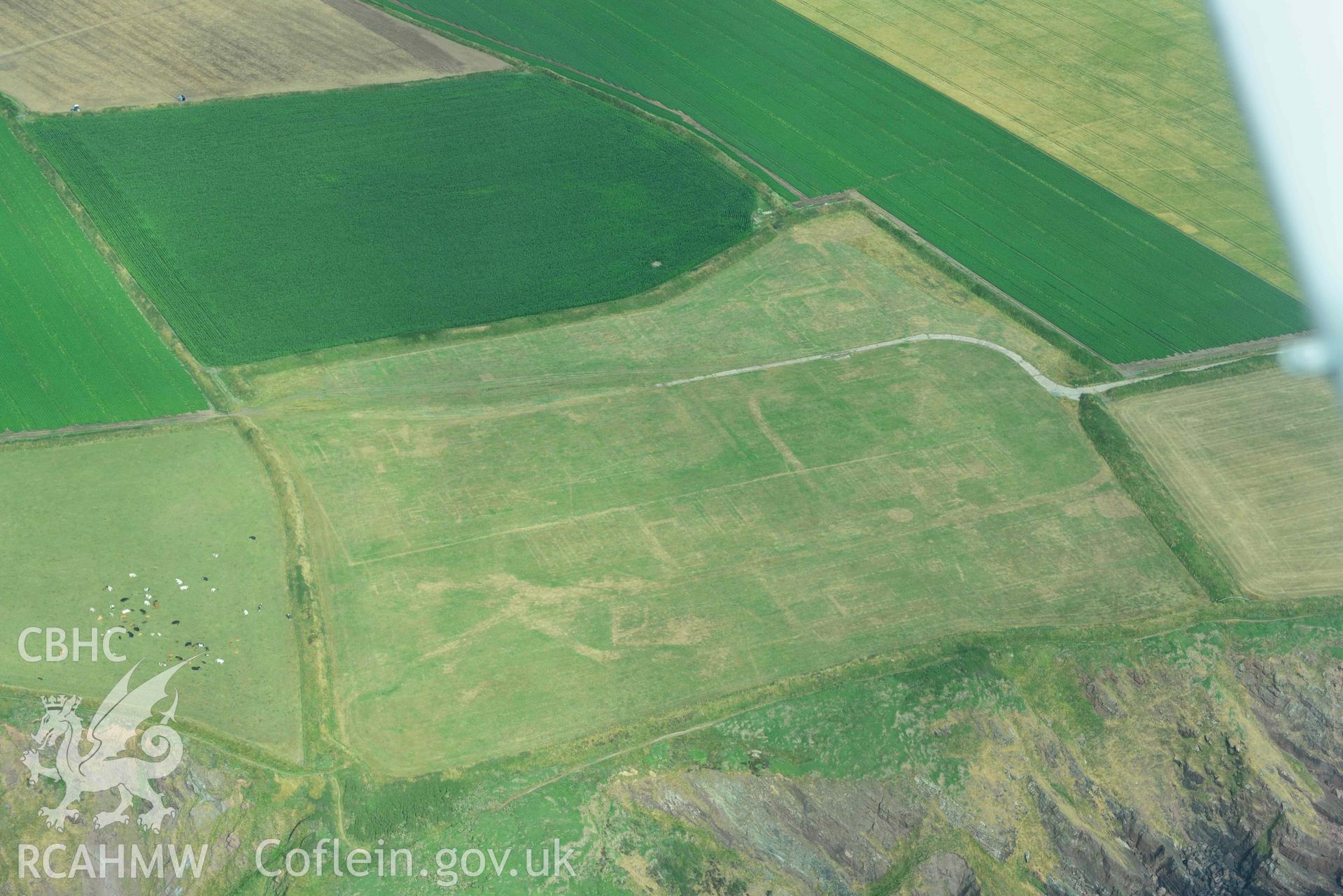 RCAHMW colour oblique aerial photograph of RAF Kete, parchmarks of demolished buildings taken on 17 July 2018 by Toby Driver (NGR: SM799047)