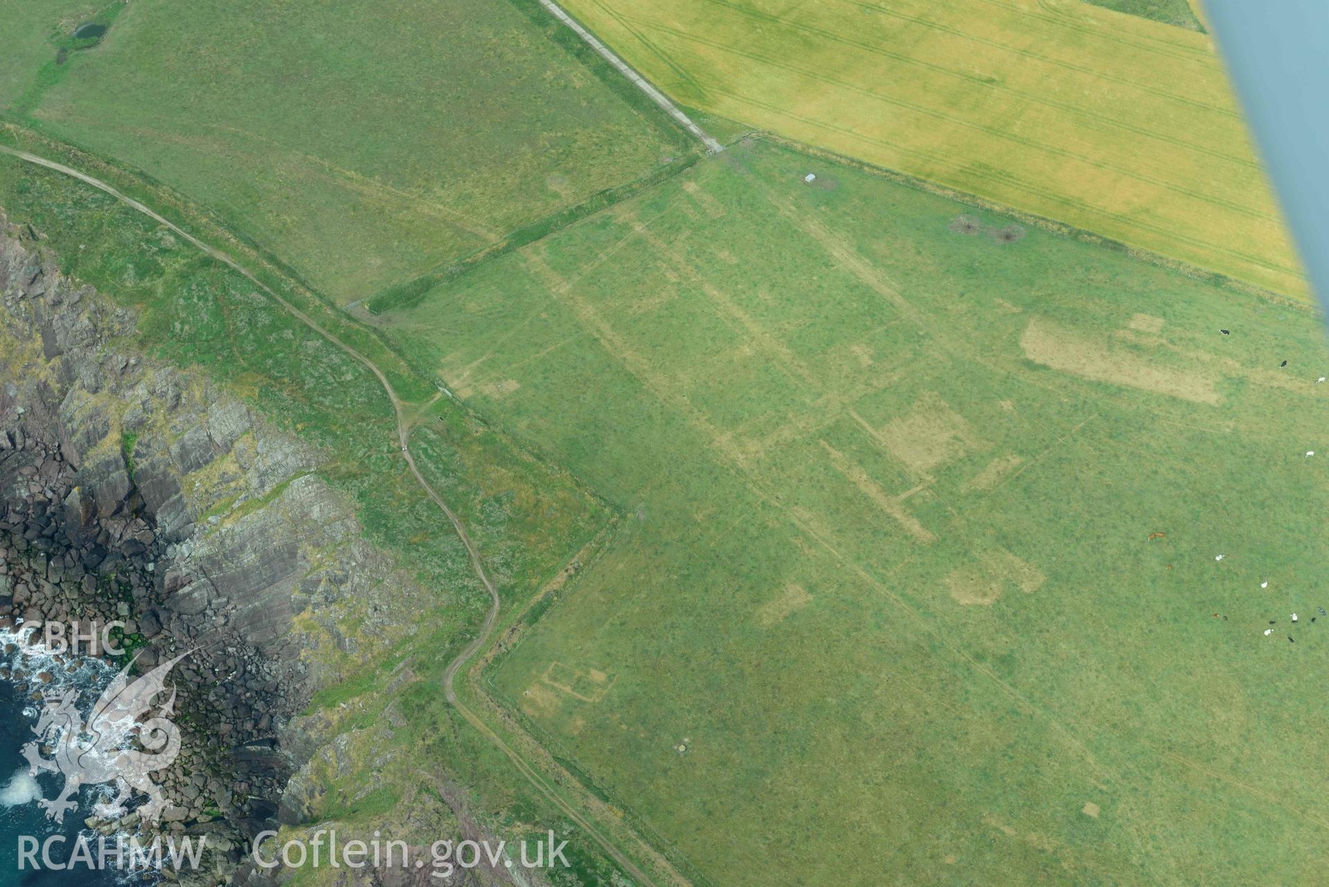 RCAHMW colour oblique aerial photograph of RAF Kete, parchmarks of demolished buildings taken on 17 July 2018 by Toby Driver (NGR: SM799040)