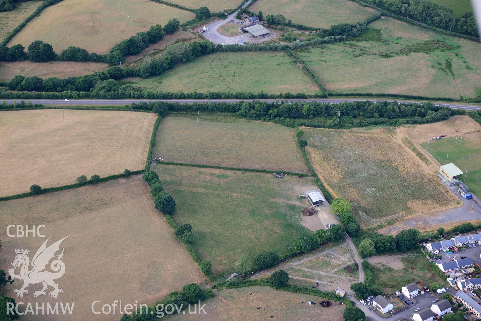 RCAHMW colour oblique aerial photograph of Whitland West, section of Roman road visible as parchmark taken on 17 July 2018 by Toby Driver (NGR: SN206170)