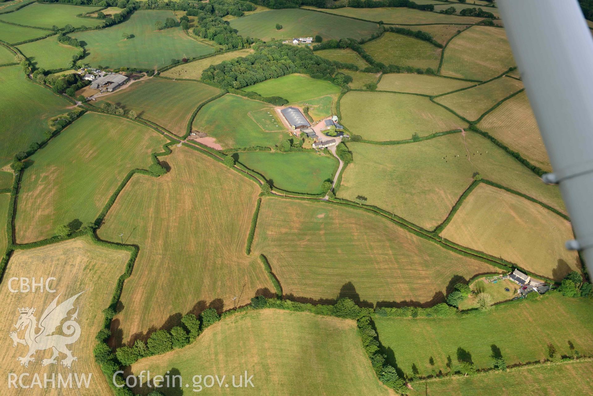 RCAHMW colour oblique aerial photograph of Roman road from Carmarthen to Kidwelly; cropmarks west of Fforest-isaf, view from W taken on 17 July 2018 by Toby Driver (NGR: SN421142)