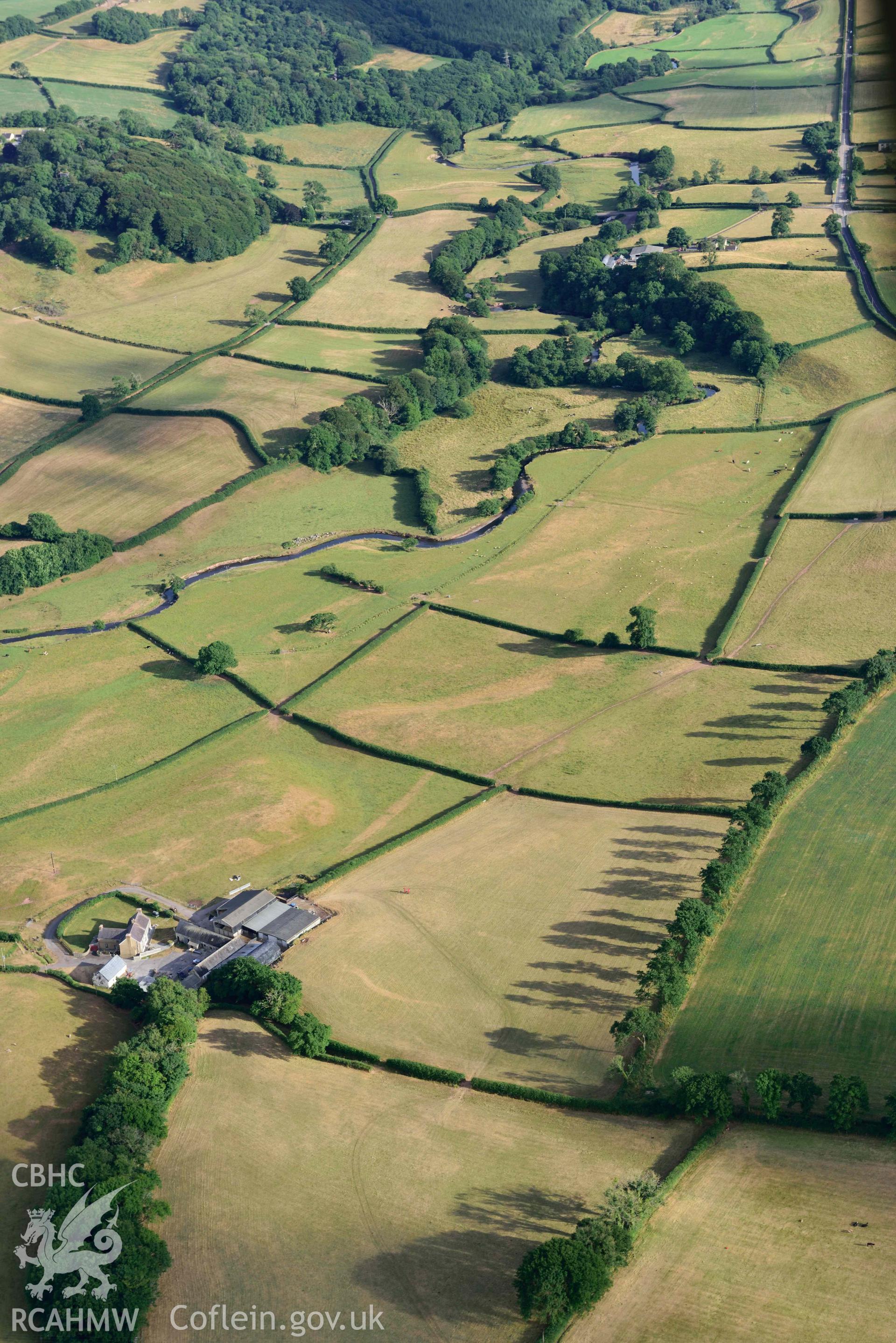 RCAHMW colour oblique aerial photograph of Roman road from Carmarthen to Kidwelly; Road parchmarks south of Nantllan taken on 17 July 2018 by Toby Driver (NGR: SN411150)