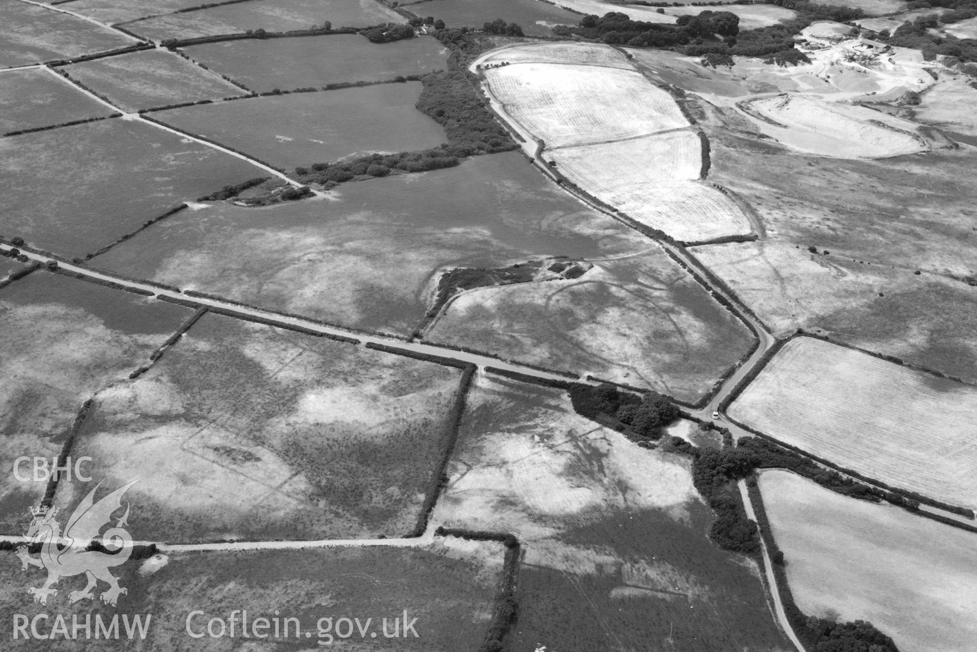 RCAHMW black and white oblique aerial photograph of Crugiau Cemmaes Barrow Cemetary, Crugiau Cemmaes banjo enclosure, Crugiau Cemmaes Southeast (Rectangular Enclosure) taken on 11 July 2018 by Toby Driver