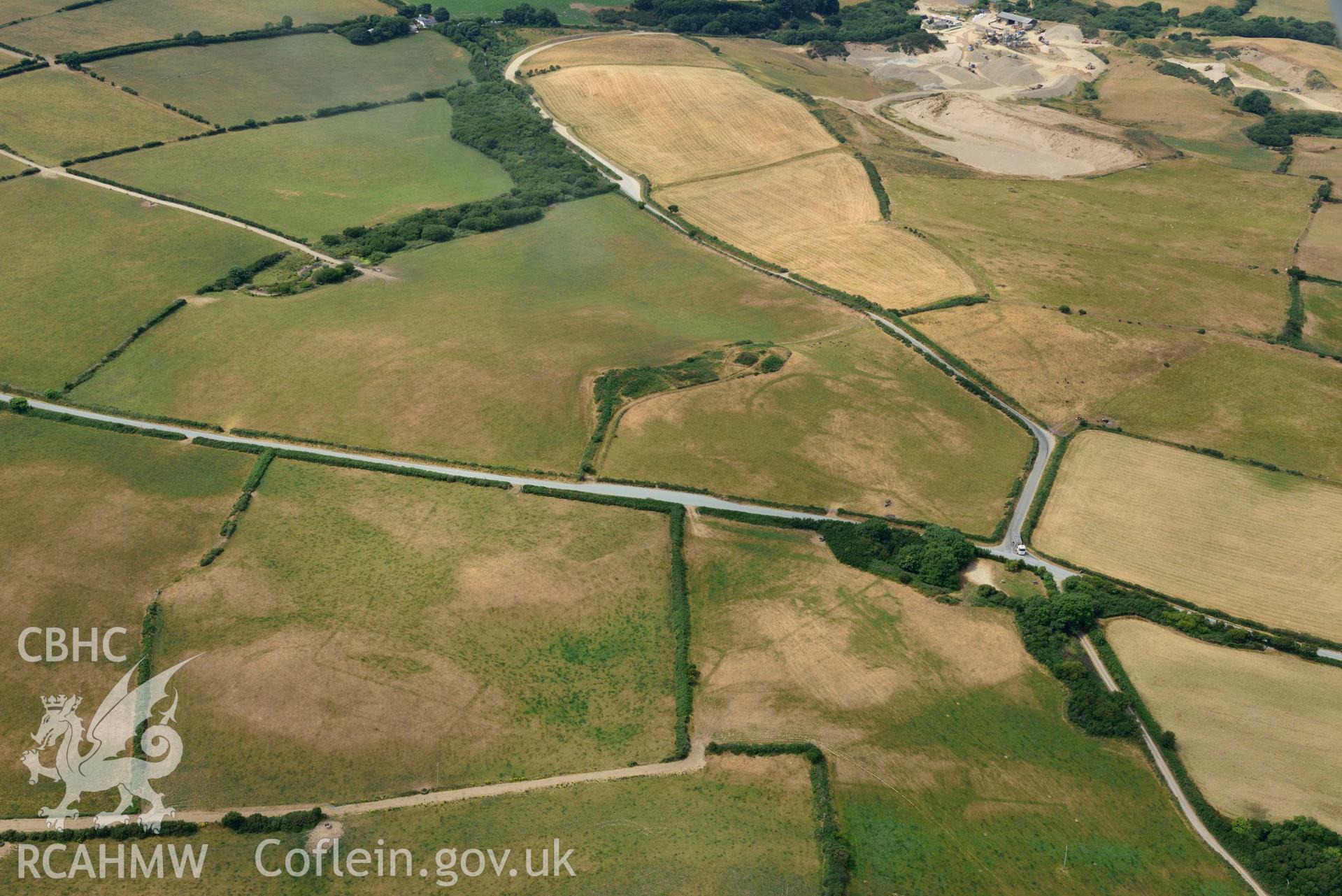 RCAHMW colour oblique aerial photograph of Crugiau Cemmaes Barrow Cemetary, Crugiau Cemmaes Banjo enclosure, Crugiau Cemmaes Southeast (Rectangular Enclosure) taken on 11 July 2018 by Toby Driver