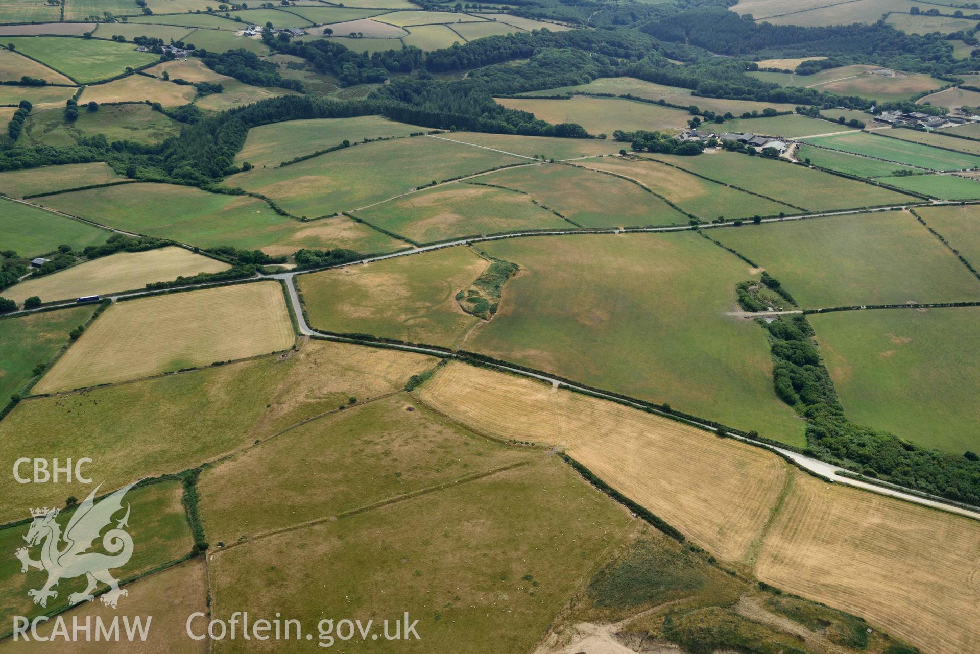 RCAHMW colour oblique aerial photograph of Crugiau Cemmaes Barrow Cemetary + Crugiau Cemmaes Banjo enclosure taken on 11 July 2018 by Toby Driver