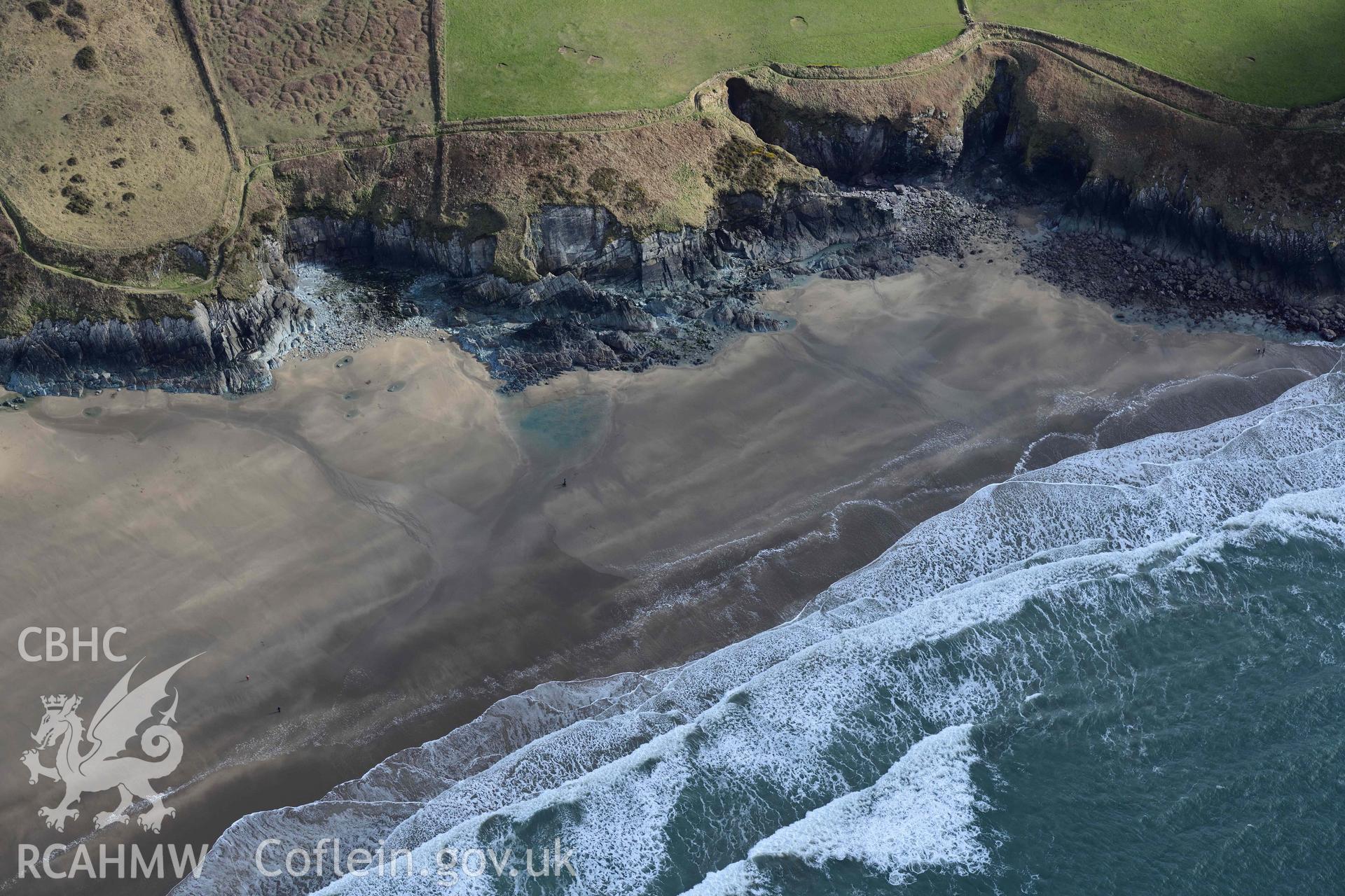 RCAHMW colour oblique aerial photograph of Whitesands Bay, Porth-mawr, south part of beach taken on 4 March 2022 by Toby Driver ((SM731267)