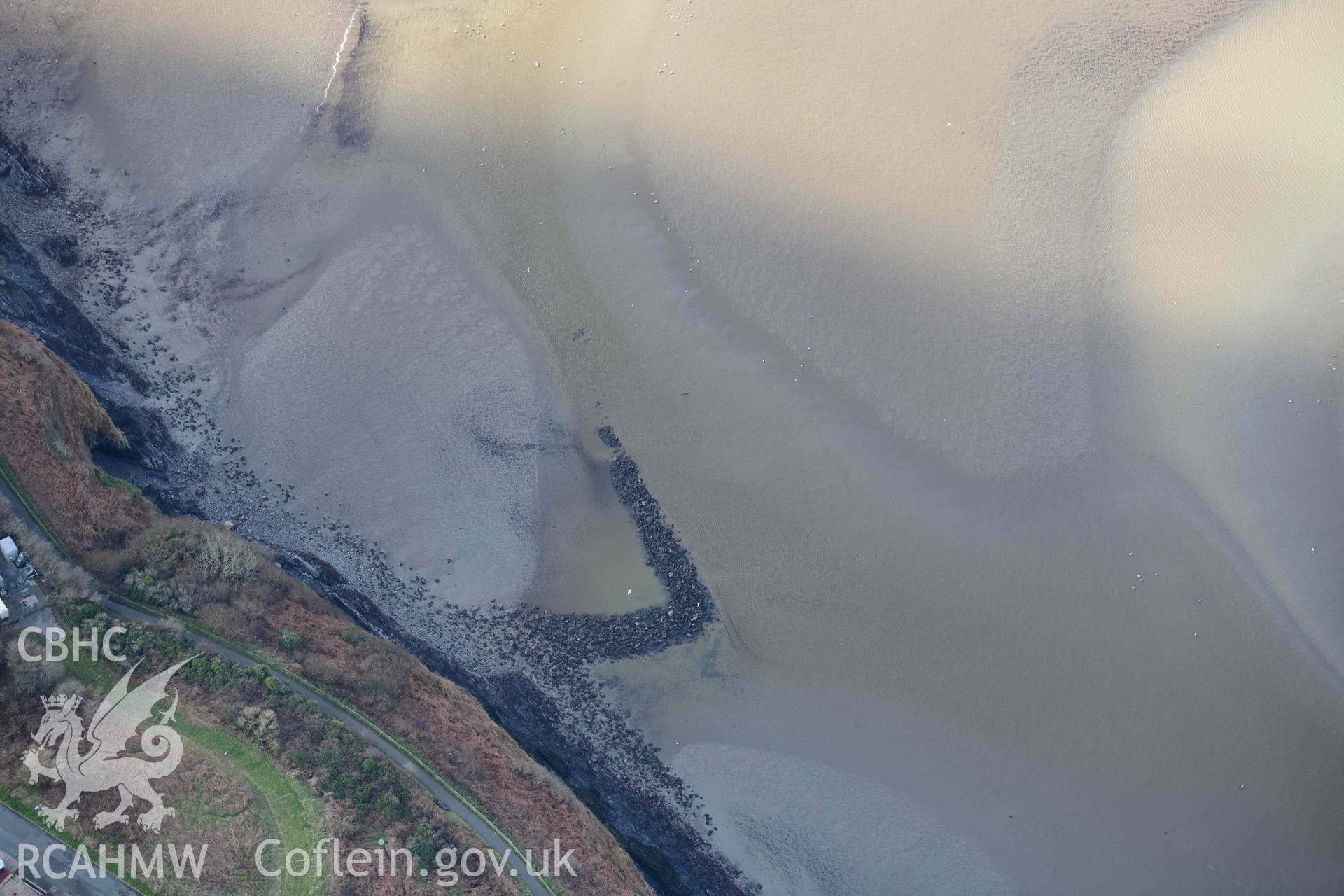 RCAHMW colour oblique aerial photograph of Fishguard harbour south-east fish trap taken on 4 March 2022 by Toby Driver ((SM952377)