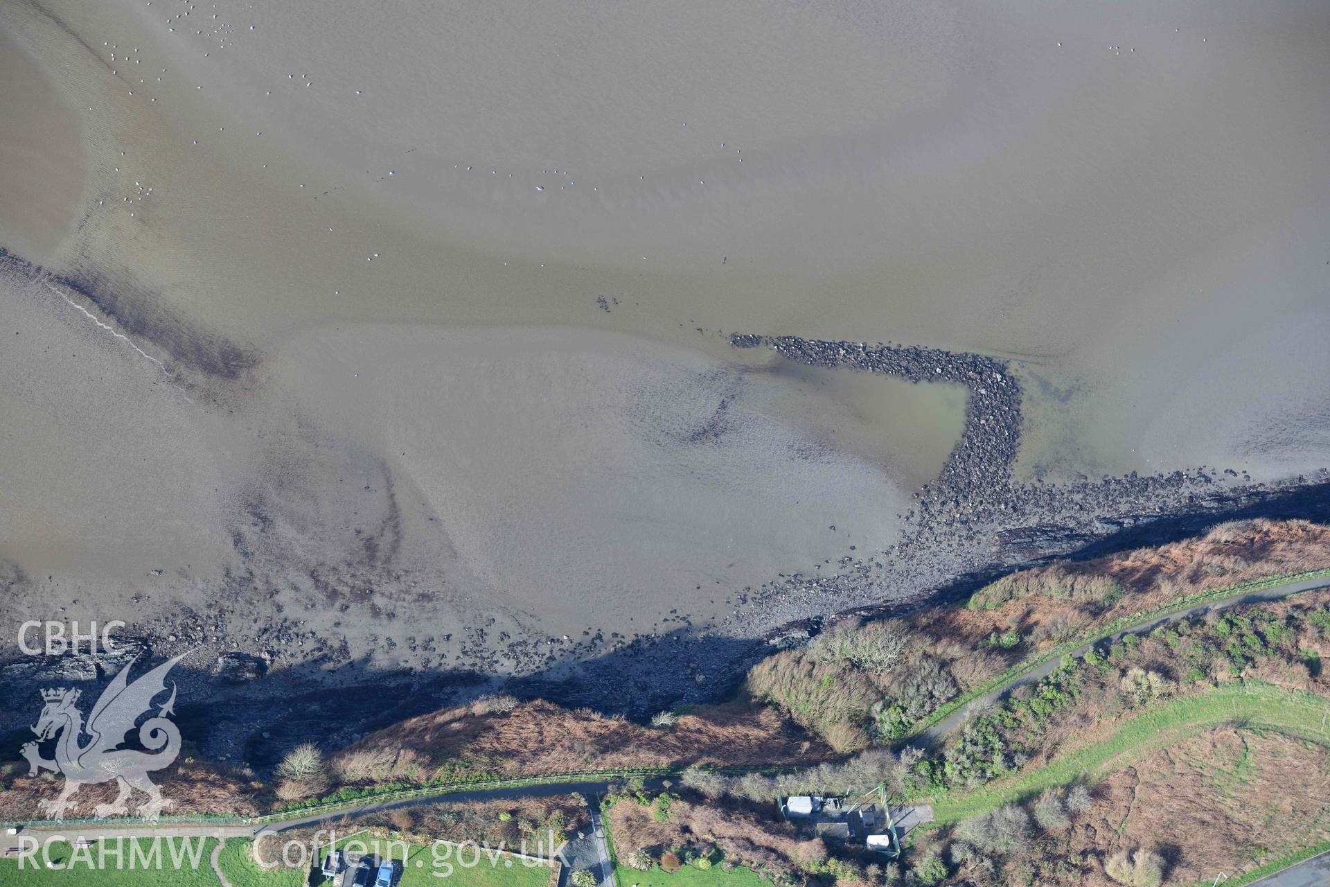 RCAHMW colour oblique aerial photograph of Fishguard harbour south-east fish trap taken on 4 March 2022 by Toby Driver ((SM952377)