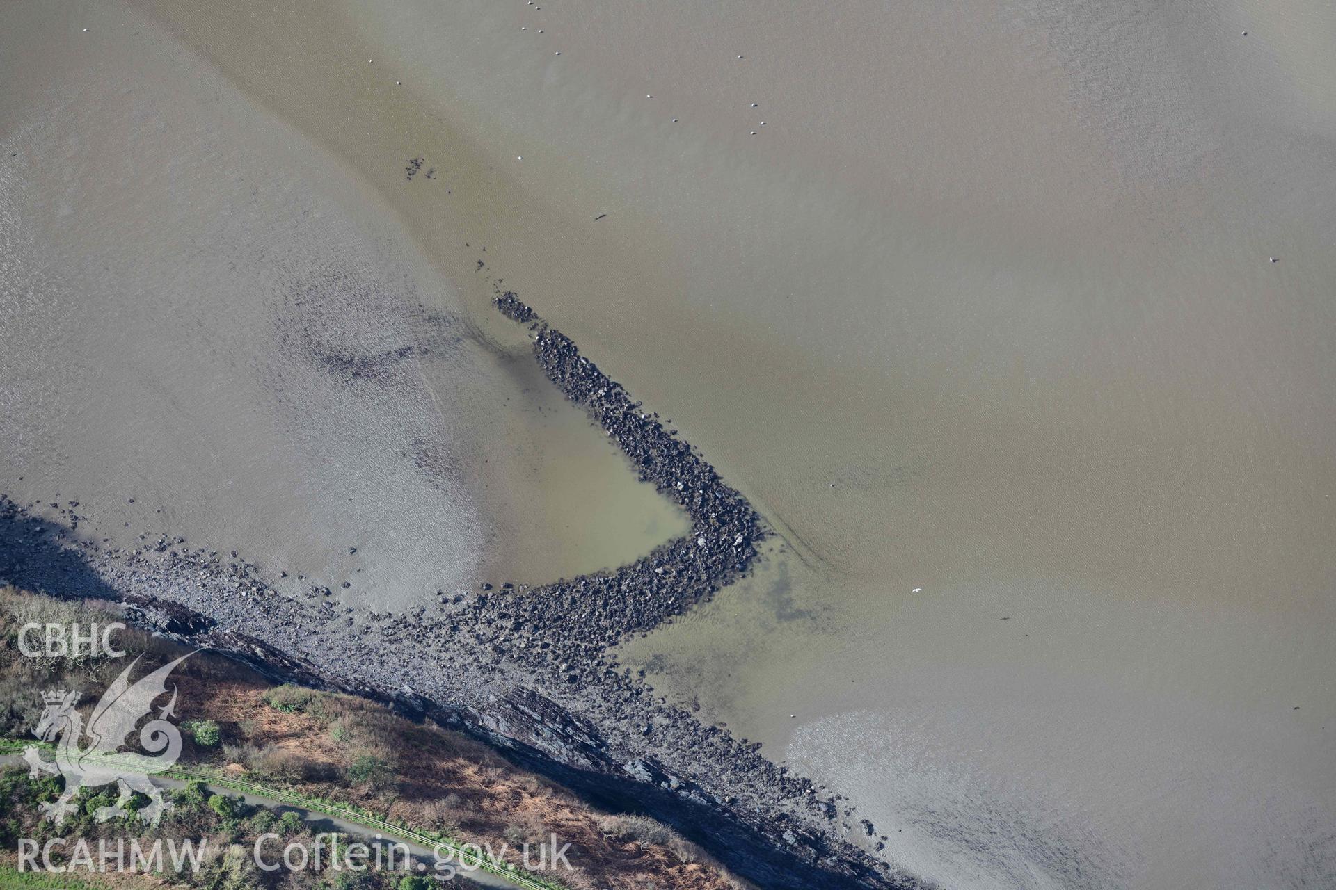 RCAHMW colour oblique aerial photograph of Fishguard harbour south-east fish trap taken on 4 March 2022 by Toby Driver ((SM952377)