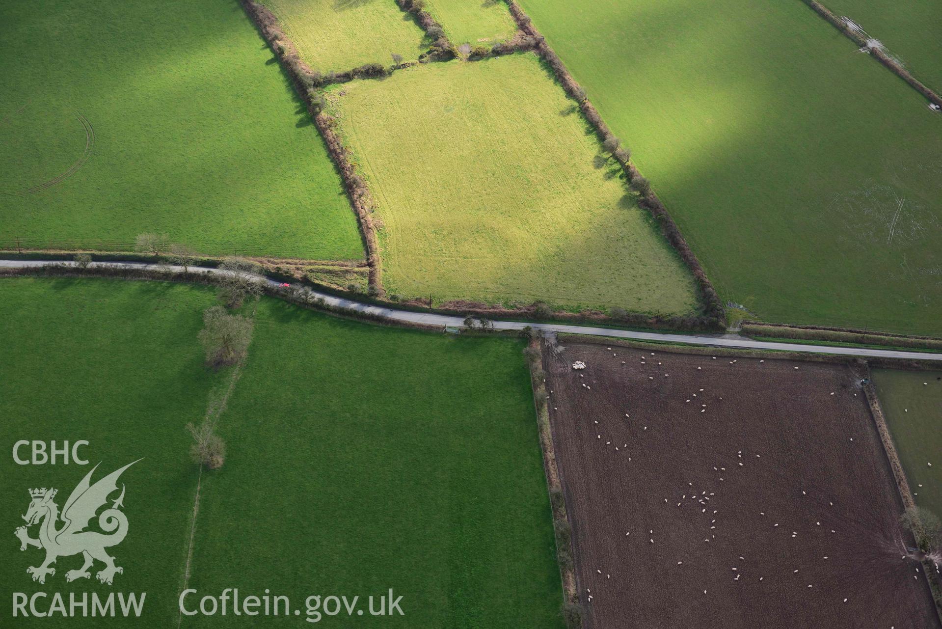 RCAHMW colour oblique aerial photograph of Castle Flemish, enclosure and villa taken on 4 March 2022 by Toby Driver ((SN007267)