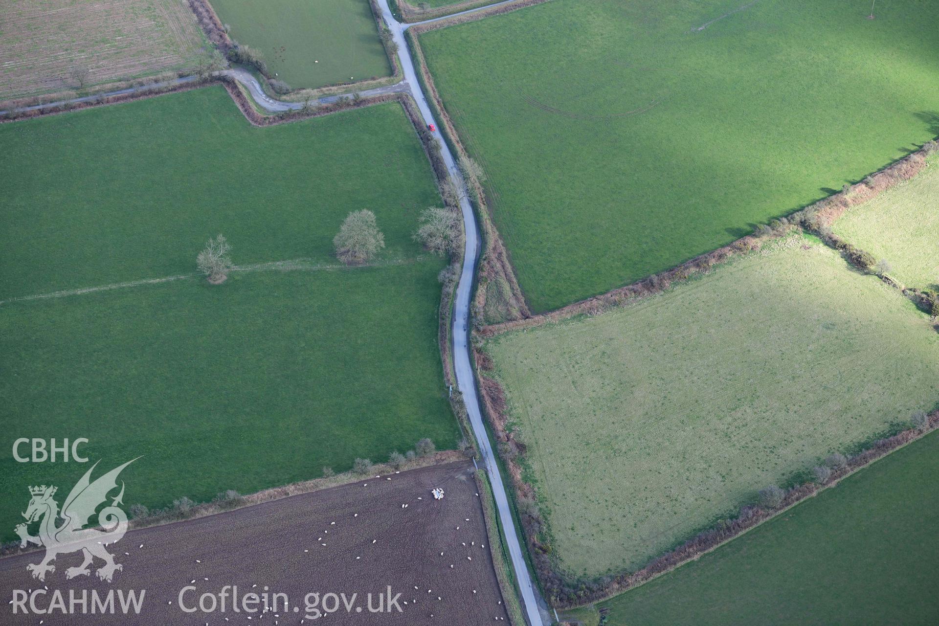 RCAHMW colour oblique aerial photograph of Castle Flemish, enclosure and villa taken on 4 March 2022 by Toby Driver ((SN007267)