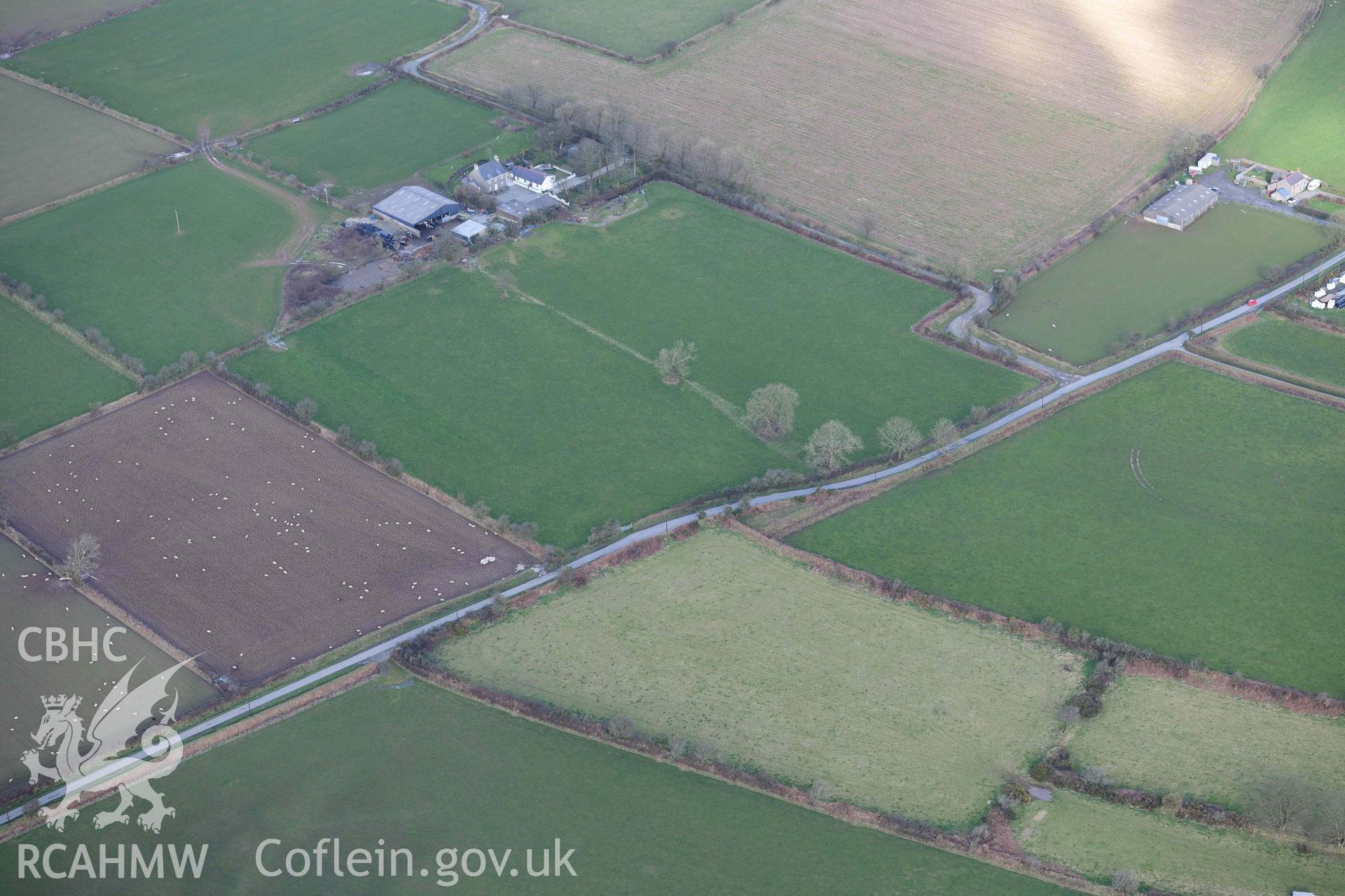 RCAHMW colour oblique aerial photograph of Castle Flemish, enclosure and villa taken on 4 March 2022 by Toby Driver ((SN007267)