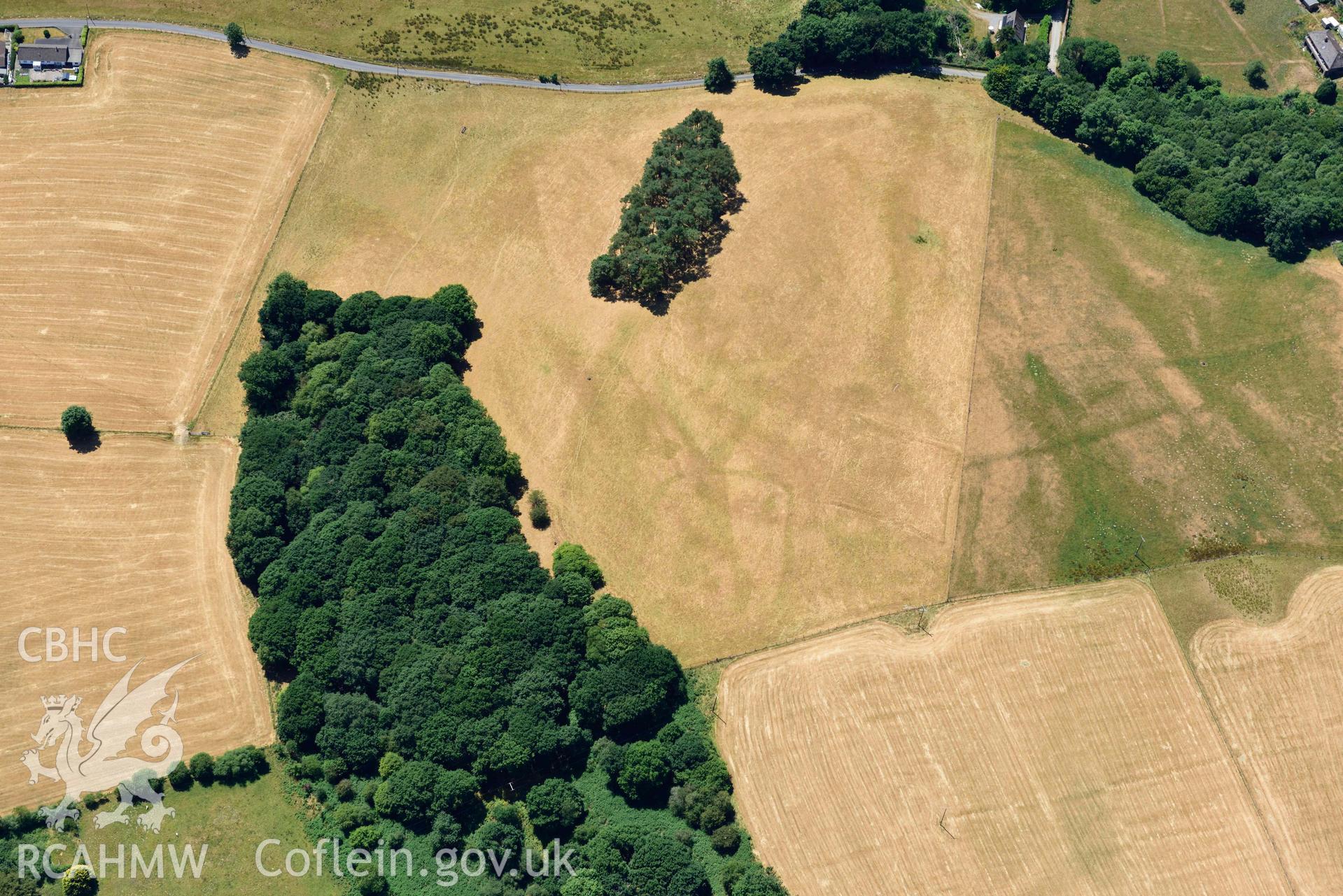 RCAHMW colour oblique aerial photograph of  Derry Ormond concentric enclosure taken on 9 July 2018 by Toby Driver