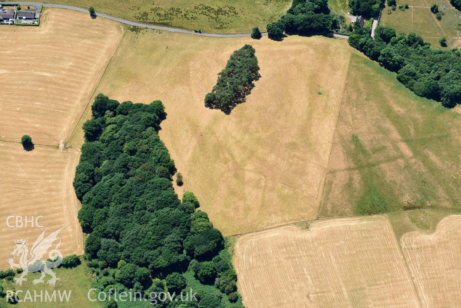 RCAHMW colour oblique aerial photograph of  Derry Ormond concentric enclosure taken on 9 July 2018 by Toby Driver