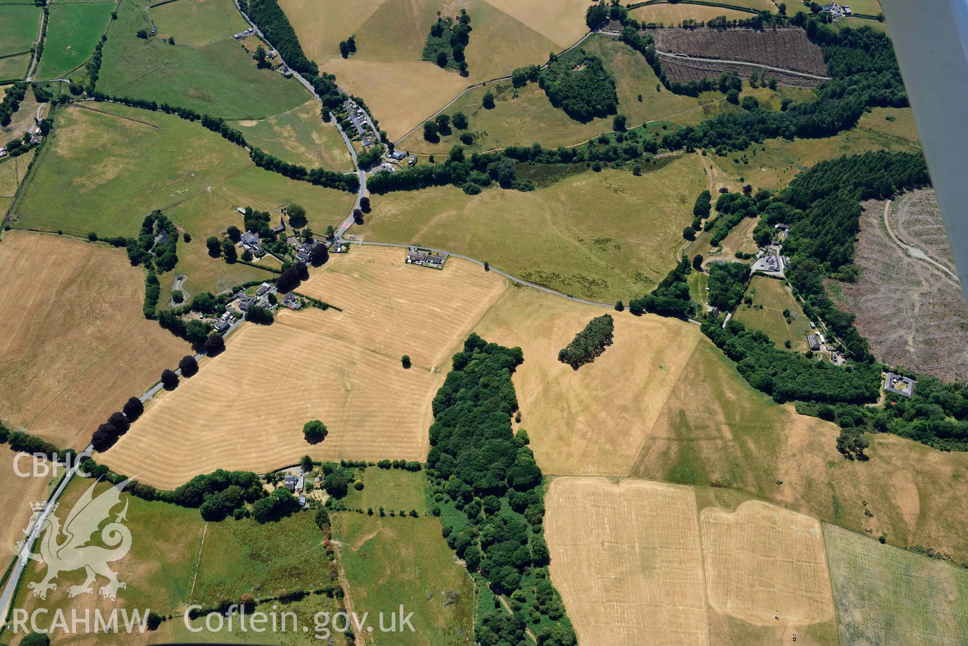 RCAHMW colour oblique aerial photograph of  Derry Ormond concentric enclosure taken on 9 July 2018 by Toby Driver