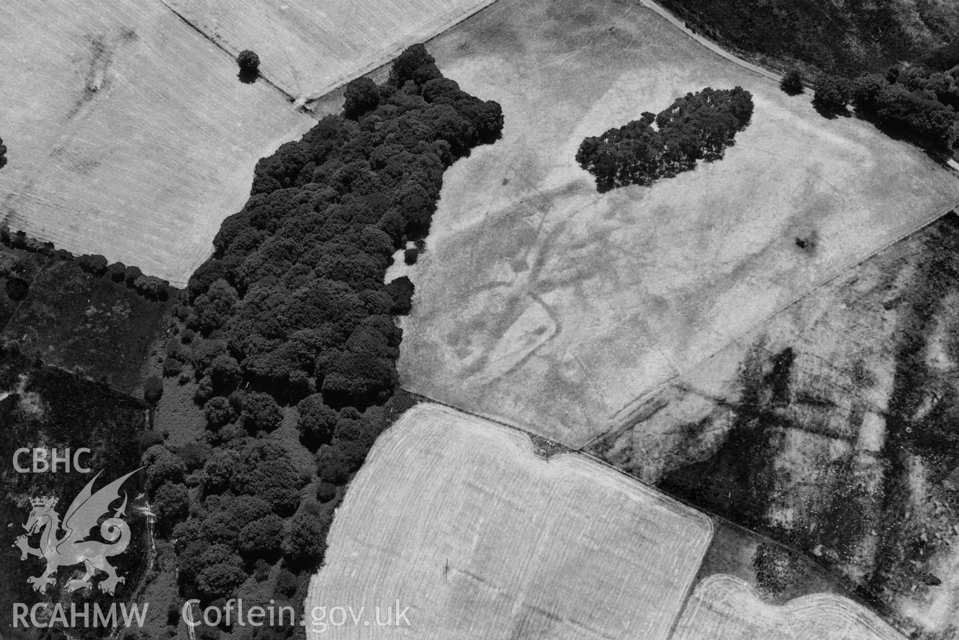 RCAHMW black and white oblique aerial photograph of  Derry Ormond concentric enclosure taken on 9 July 2018 by Toby Driver