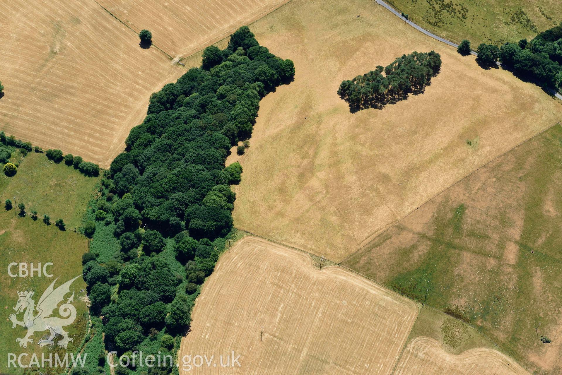 RCAHMW colour oblique aerial photograph of  Derry Ormond concentric enclosure taken on 9 July 2018 by Toby Driver