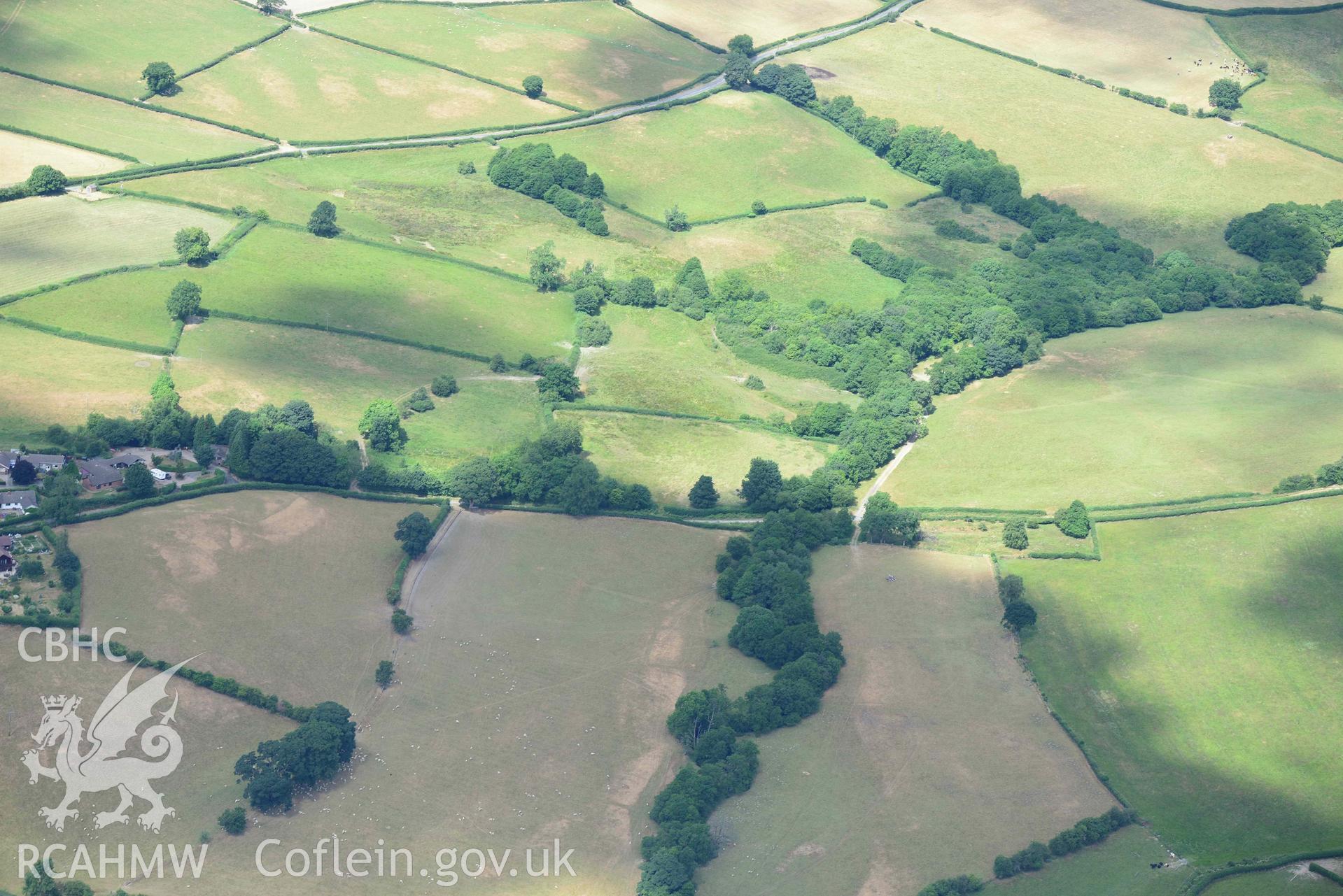 RCAHMW black and white oblique aerial photograph of Painscastle ring ditch taken on 9 July 2018 by Toby Driver