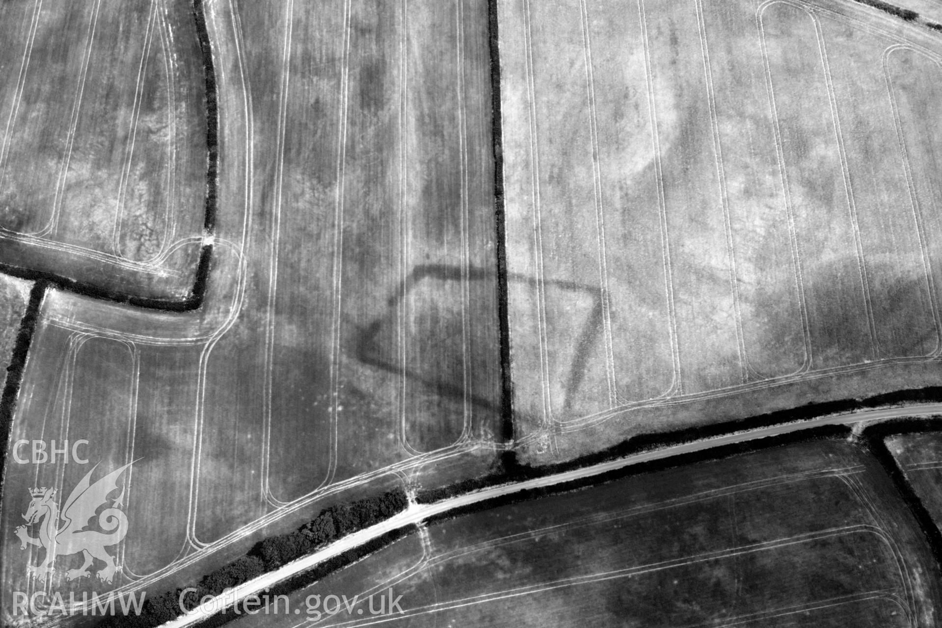 RCAHMW black and white oblique aerial photograph of Court Llacca cropmark taken on 9 July 2018 by Toby Driver