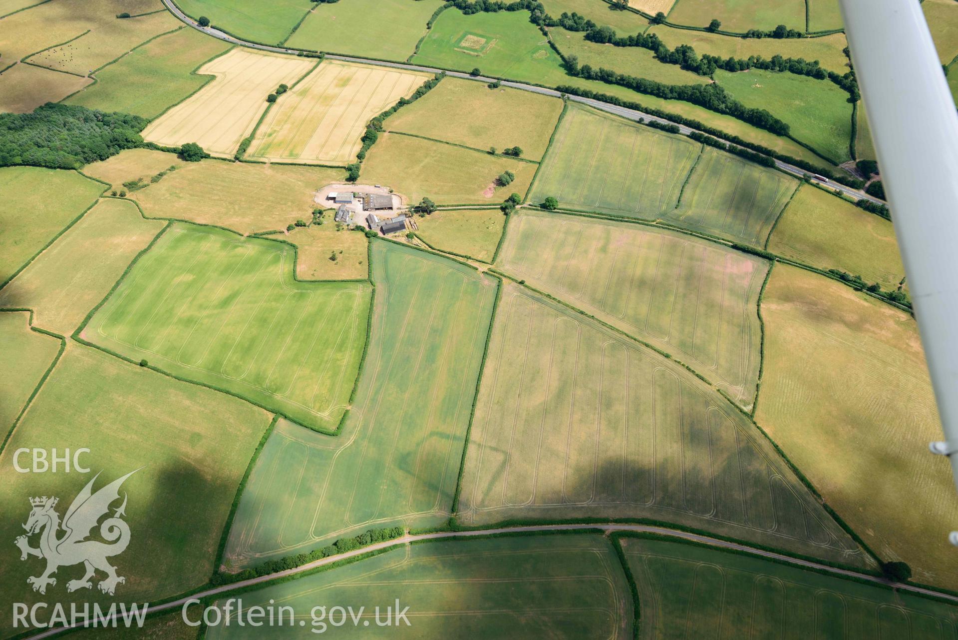 RCAHMW colour oblique aerial photograph of Court Llacca cropmark taken on 9 July 2018 by Toby Driver