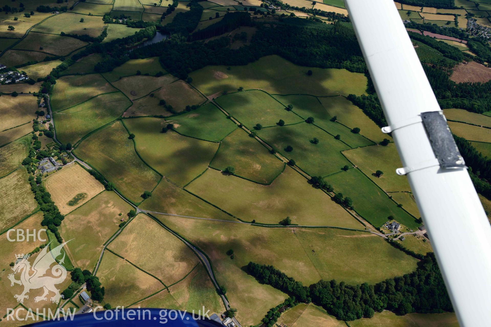 RCAHMW colour oblique aerial photograph of Pool Farm roman road west of Pool Farm taken on 9 July 2018 by Toby Driver