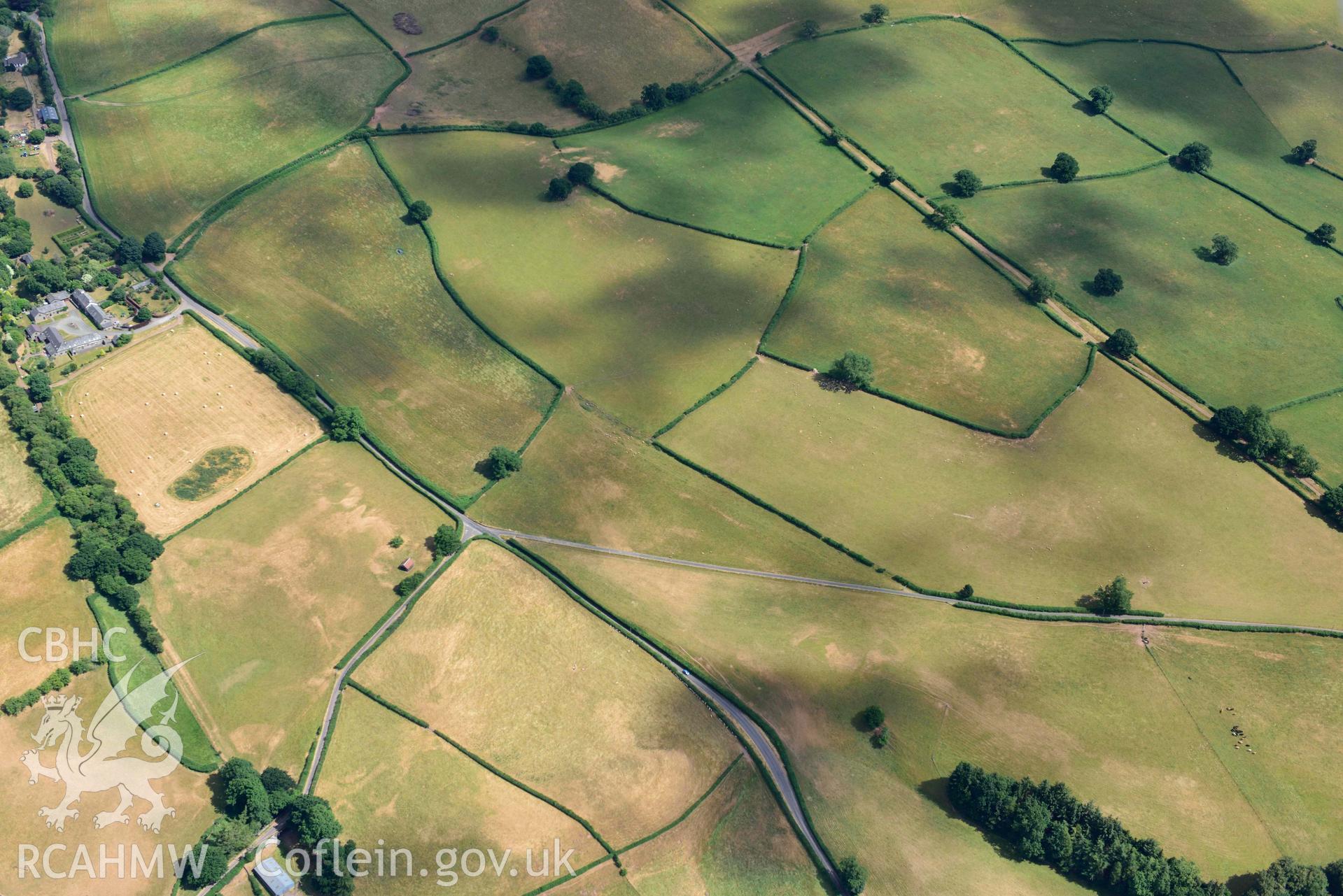 RCAHMW black and white oblique aerial photograph of Pool Farm roman road west of Pool Farm taken on 9 July 2018 by Toby Driver