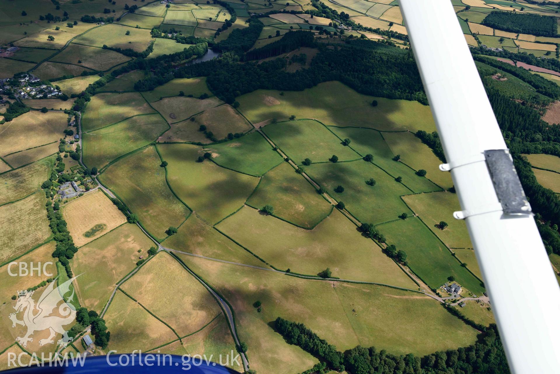 RCAHMW colour oblique aerial photograph of Pool Farm roman road west of Pool Farm taken on 9 July 2018 by Toby Driver