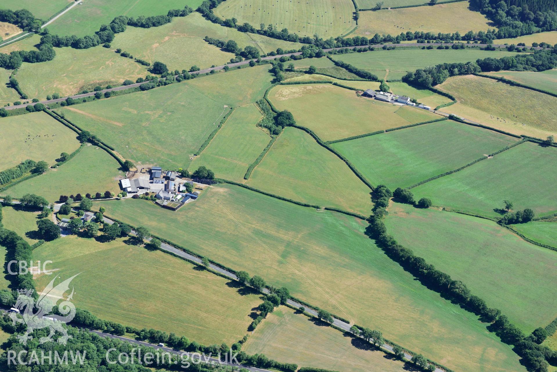 RCAHMW black and white oblique aerial photograph of Moor round barrow taken on 9 July 2018 by Toby Driver