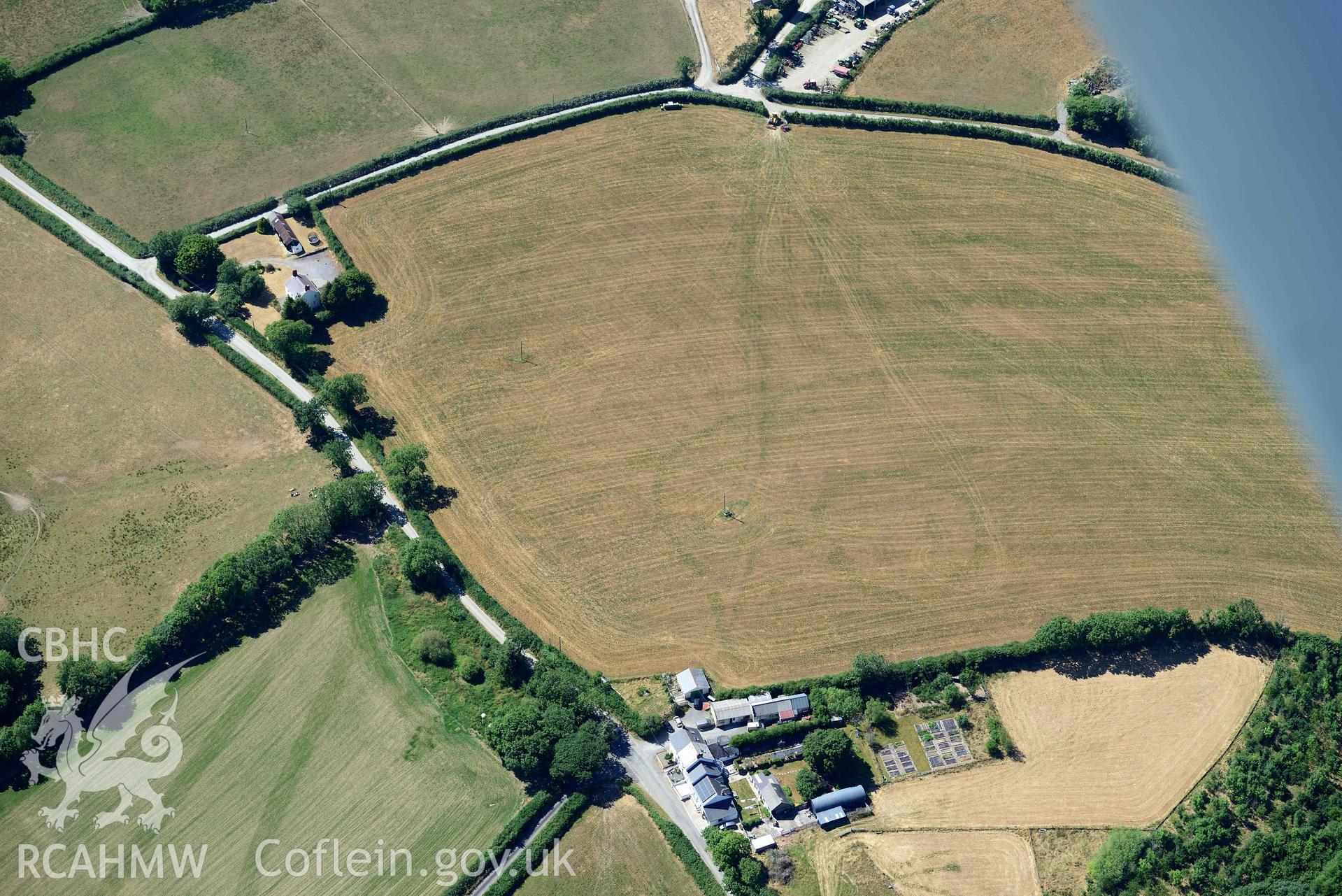 RCAHMW black and white oblique aerial photograph of Plas y Parc cropmark enclosure taken on 9 July 2018 by Toby Driver