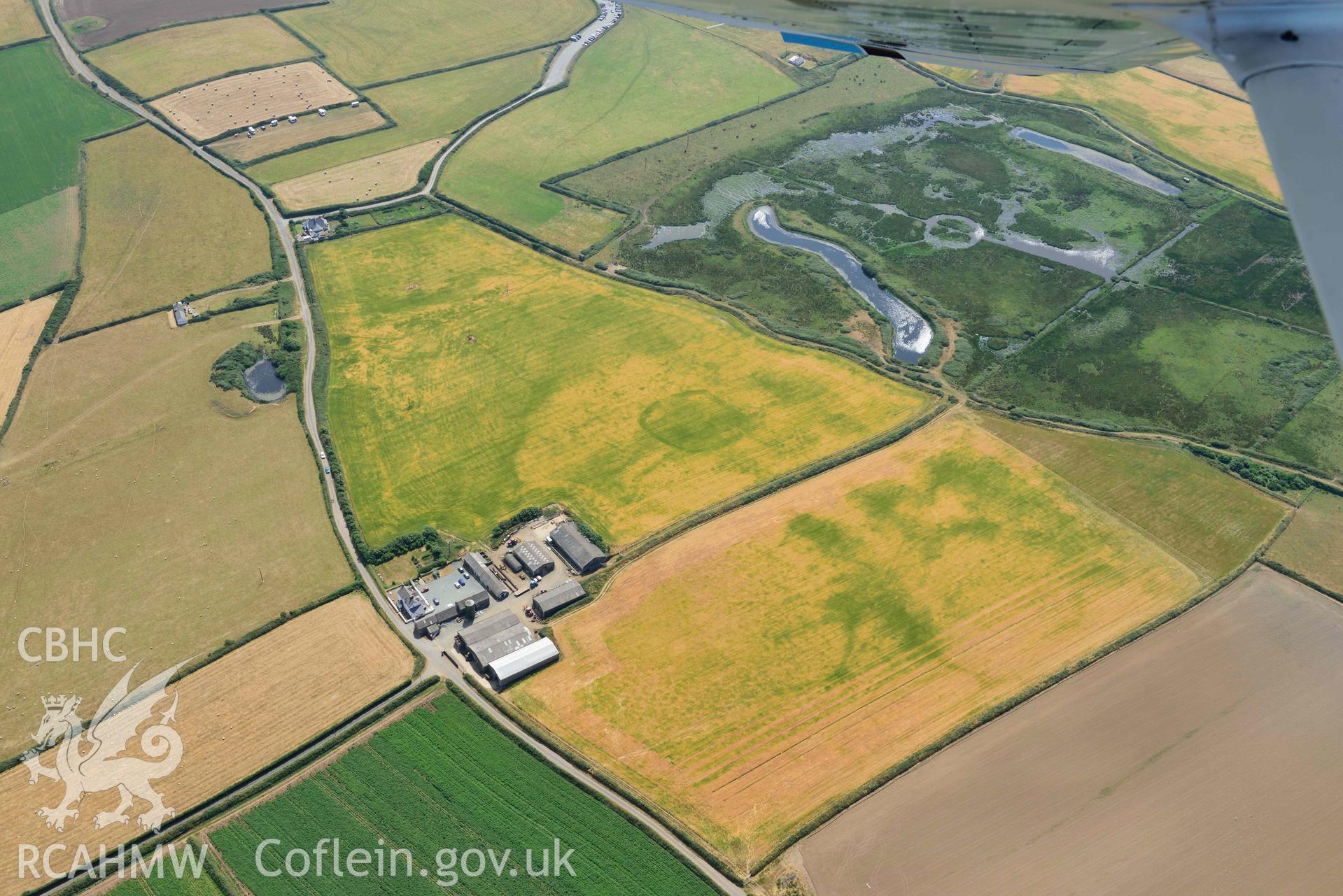 Aerial photography of Trehill Farm defended enclosure, Marloes Aerial reconnaissance survey for the CHERISH Project. Crown Copyright: CHERISH PROJECT 2018. Produced with EU funds through the Ireland Wales Co-operation Programme 2014-2020. All material made freely available through the Open Government Licence.