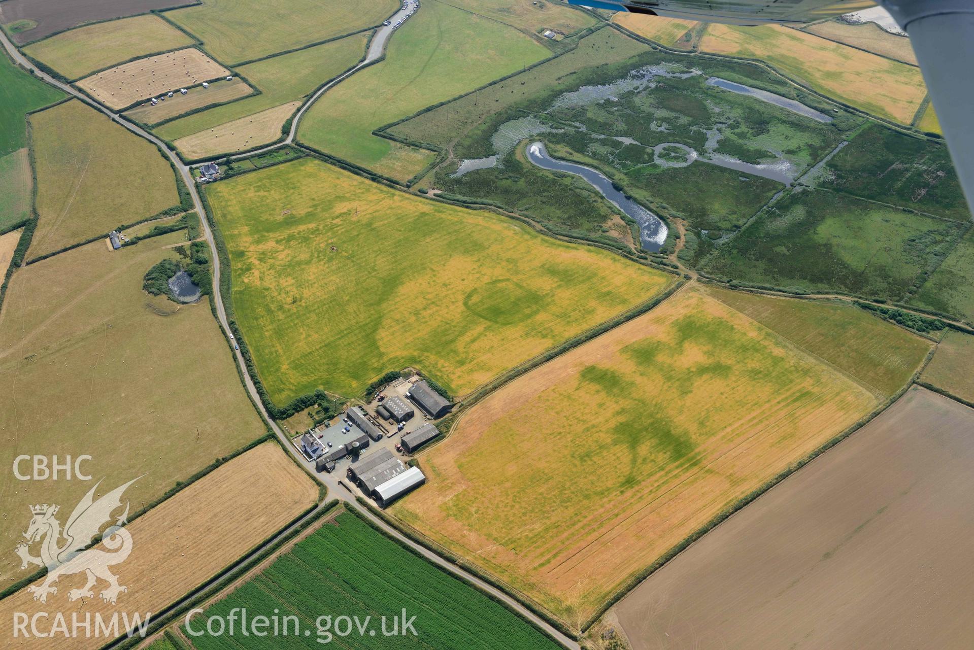 Aerial photography of Trehill Farm defended enclosure, Marloes Aerial reconnaissance survey for the CHERISH Project. Crown Copyright: CHERISH PROJECT 2018. Produced with EU funds through the Ireland Wales Co-operation Programme 2014-2020. All material made freely available through the Open Government Licence.