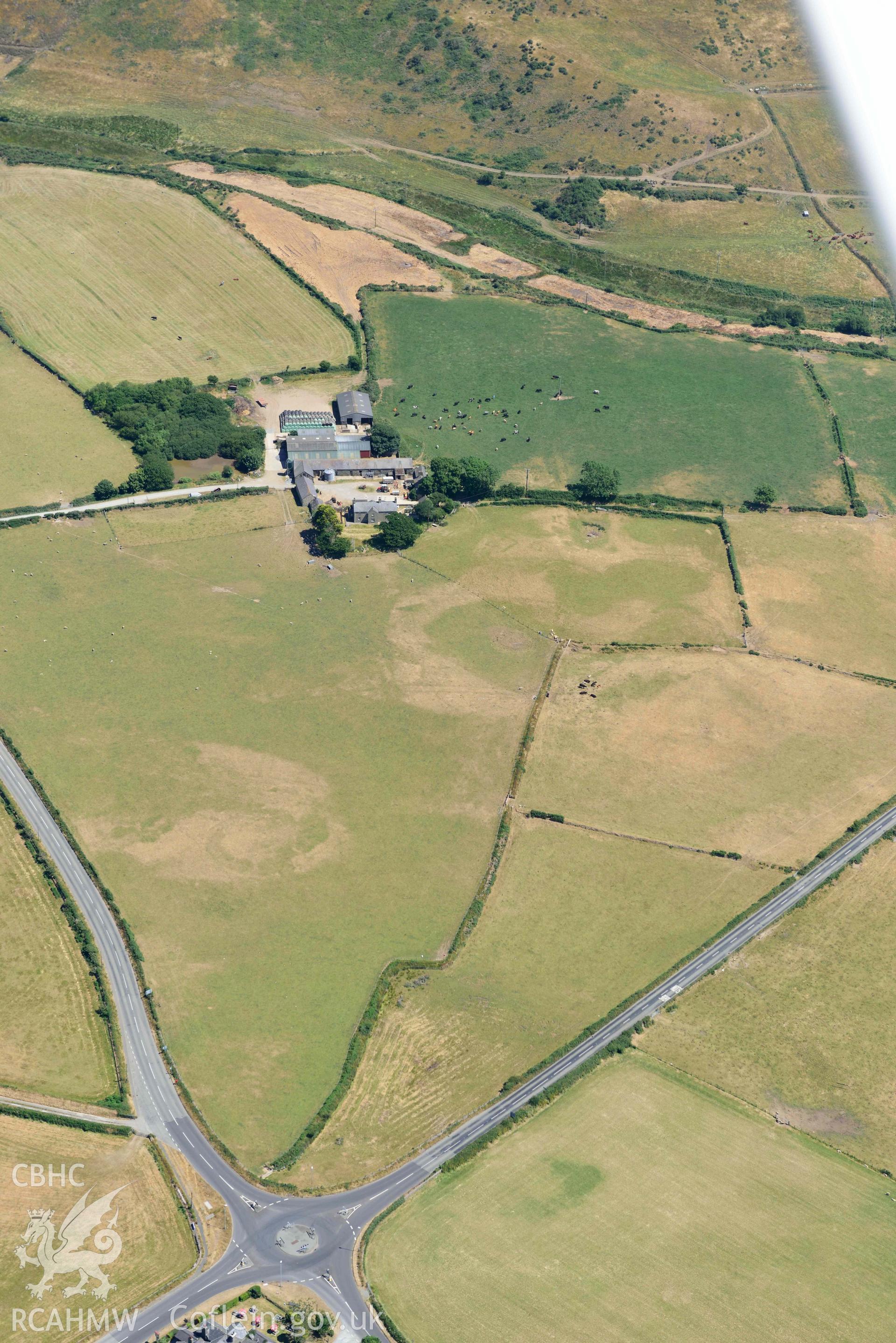 Aerial photograph: Bodtacho Ddu, prehistoric defended enclosure and cropmarks. Crown: CHERISH PROJECT 2018. Produced with EU funds through the Ireland Wales Co-operation Programme 2014-2020 (NGR SH299394)