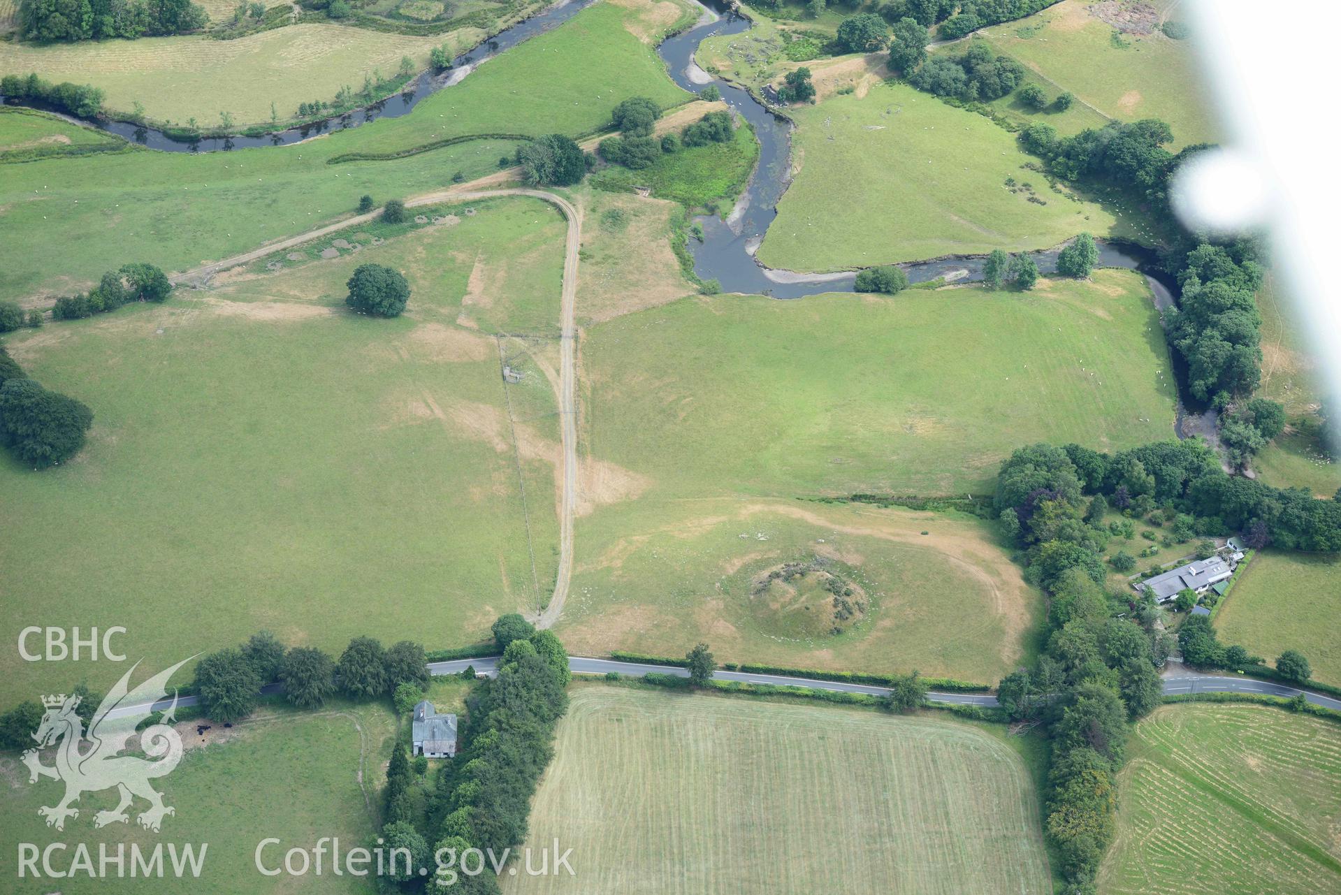 Aerial photograph: Tomen Llanio motte, with parchmarks. Crown: CHERISH PROJECT 2018. Produced with EU funds through the Ireland Wales Co-operation Programme 2014-2020 (NGR SN660579)