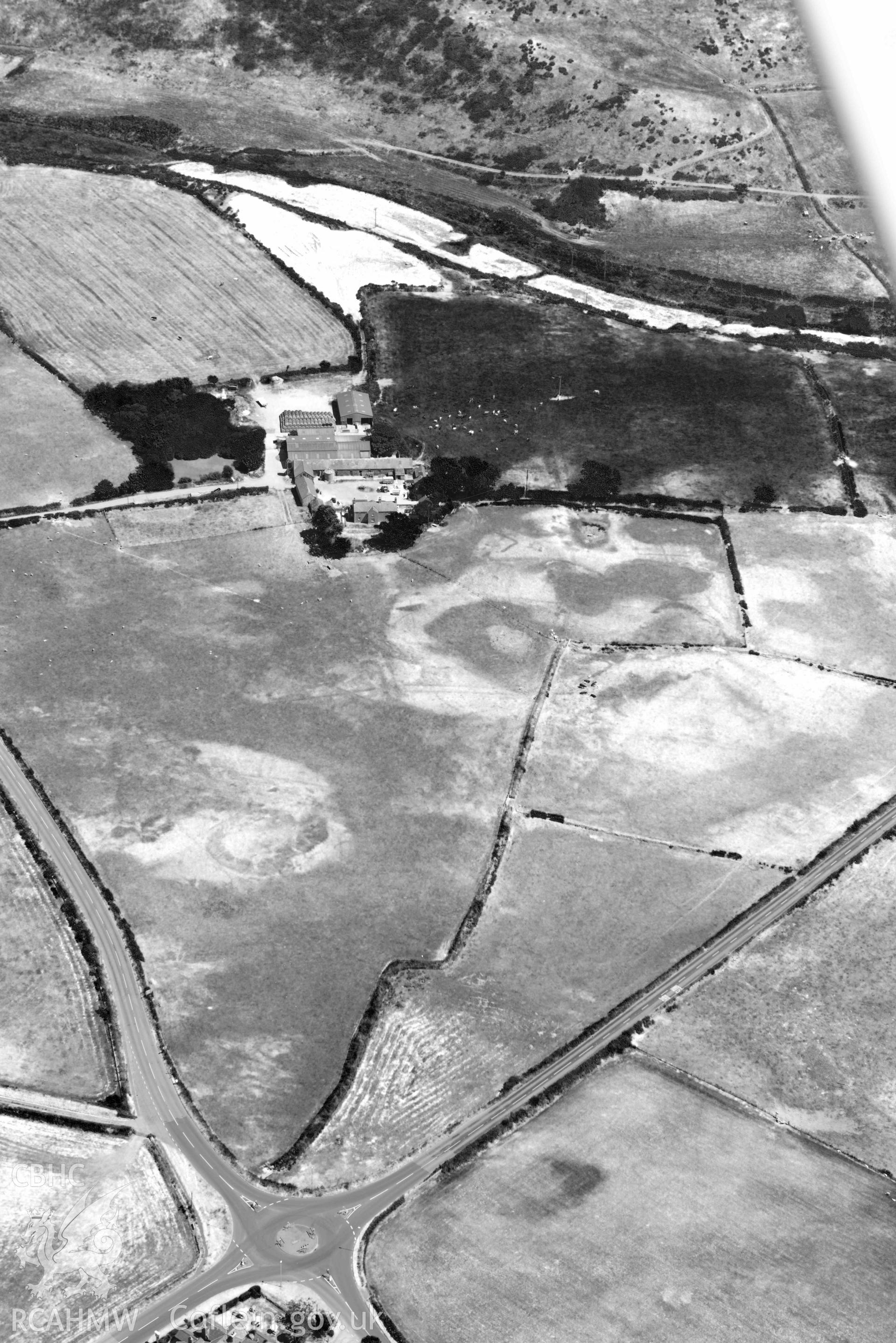 Aerial photograph: Bodtacho Ddu, prehistoric defended enclosure and cropmarks. Crown: CHERISH PROJECT 2018. Produced with EU funds through the Ireland Wales Co-operation Programme 2014-2020 (NGR SH299394)