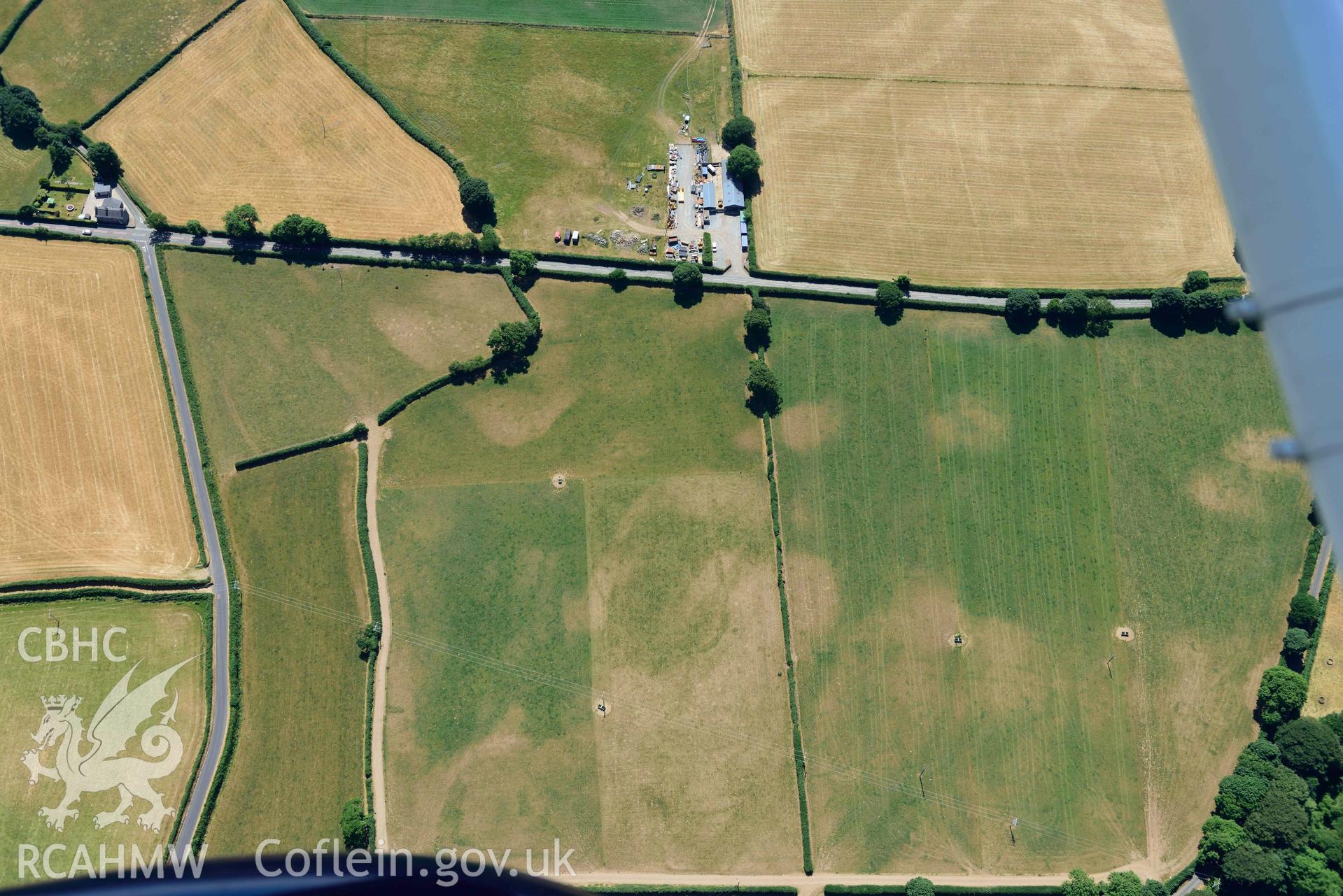 Aerial photograph: Enclosures and early field system cropmarks, Cefail y Bont, Efailnewydd. Crown: CHERISH PROJECT 2018. Produced with EU funds through the Ireland Wales Co-operation Programme 2014-2020 (NGR SH347365)